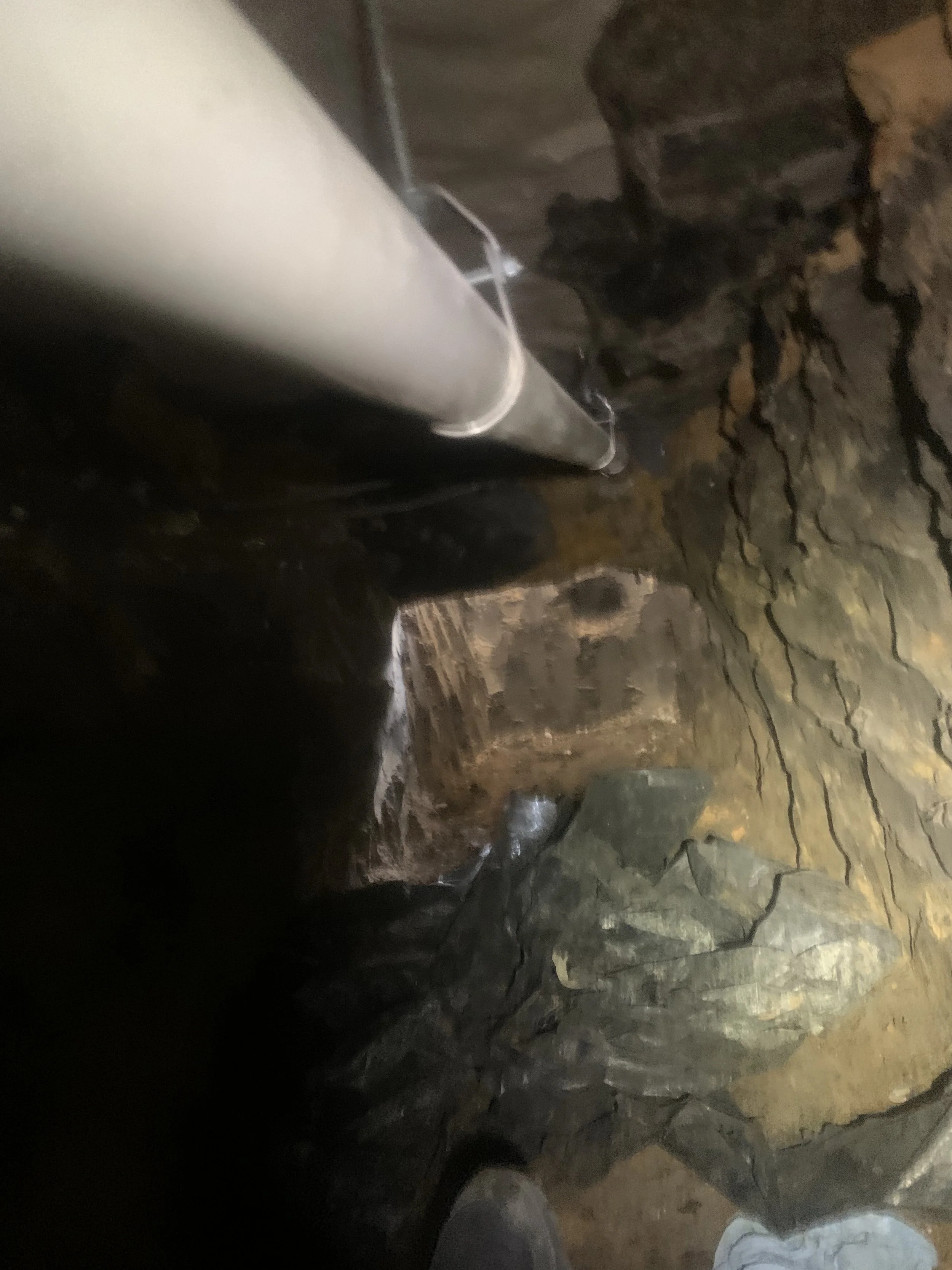 residential sewer tunnel pvc repair excavation and pipe running across top of frame