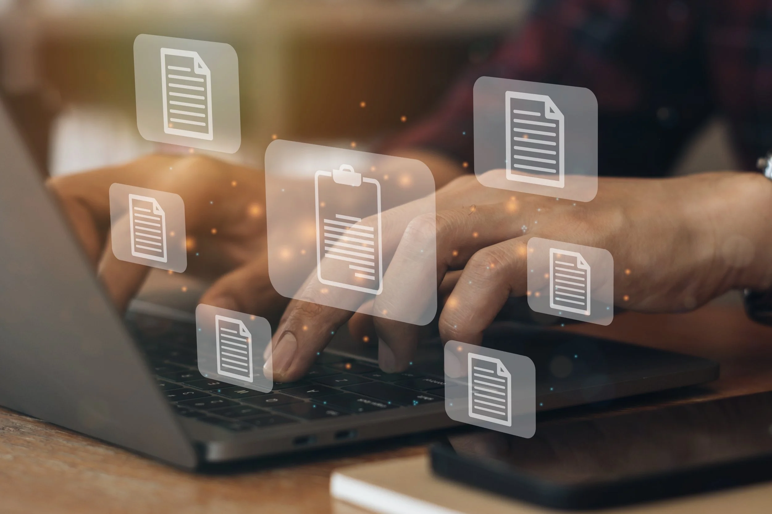 Person using a laptop with digital icons of documents floating above, representing digital documents or files.