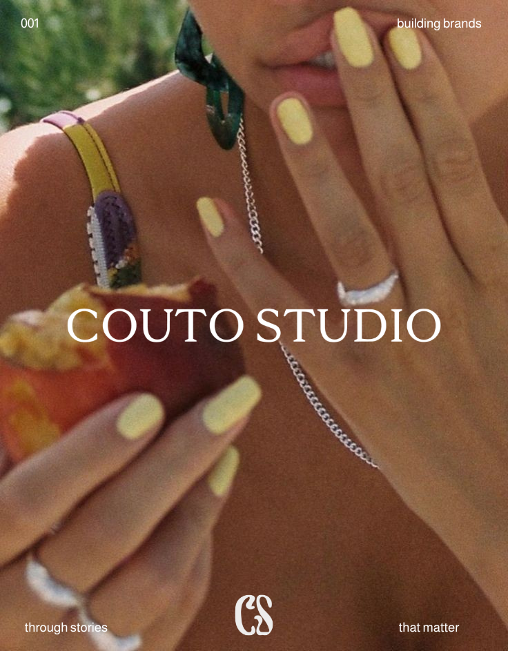 Close-up of a woman with yellow nail polish holding a slice of pizza, showing jewelry and a floral strap on her shoulder, with the text 'COUTO STUDIO' and smaller phrases 'building brands,' 'through stories,' and 'that matter'.