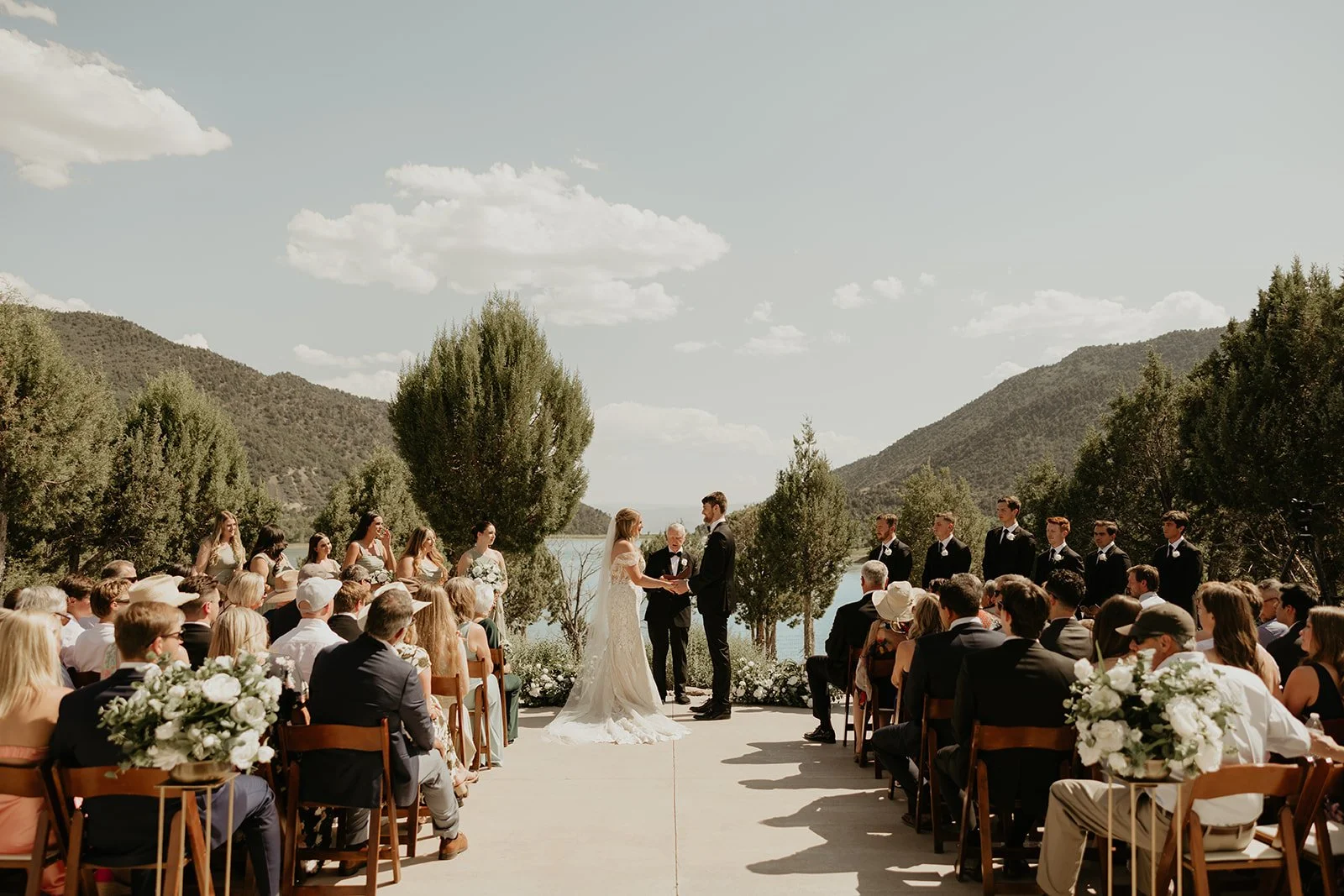 A waterfront patio at Vista View Events showing a wedding ceremony with mountain views