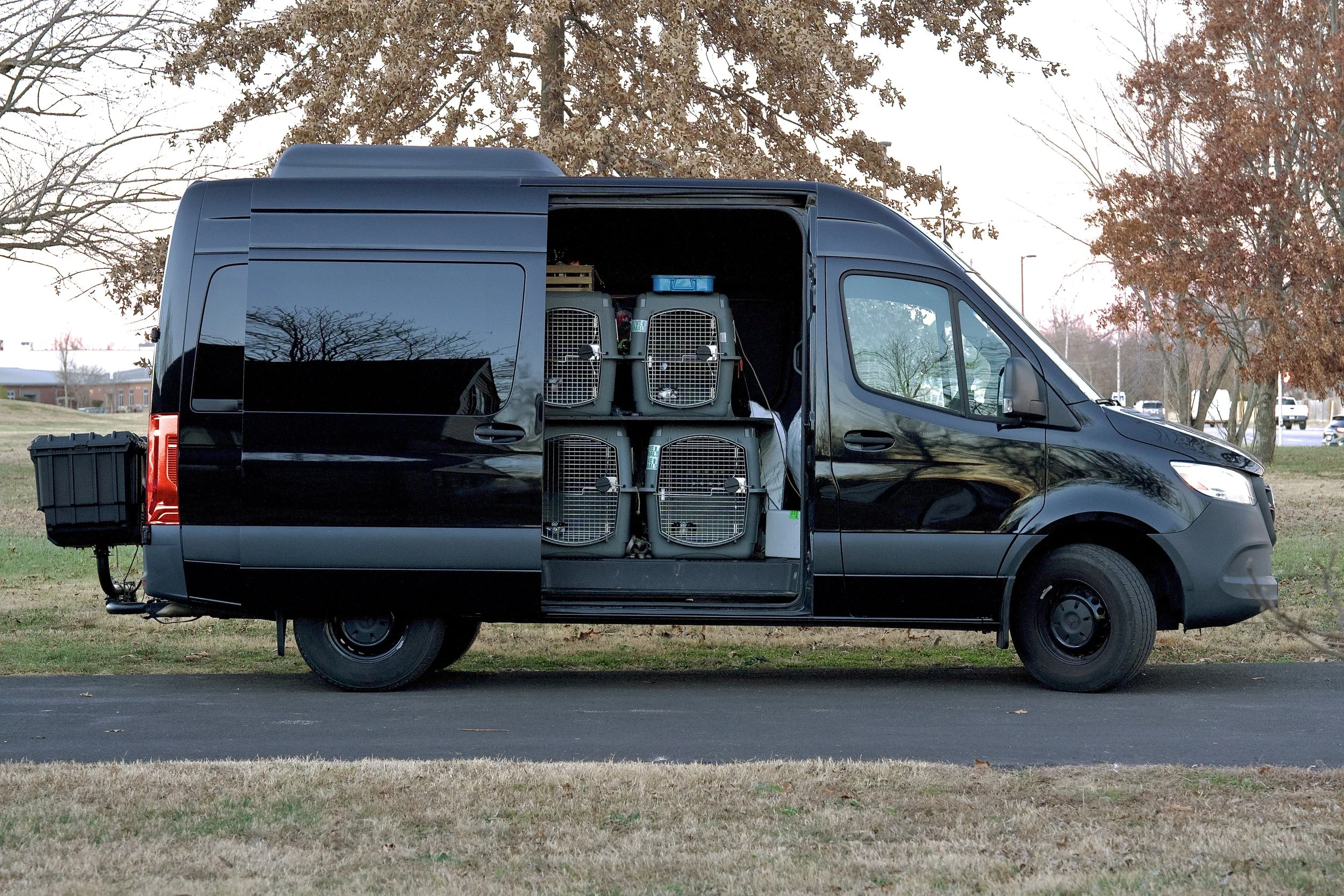 Backup generator on the back, six crates and a bed within.