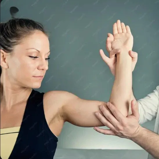 The image shows a physical therapist providing manual assistance to a patient during an arm range-of-motion or stretching exercise.