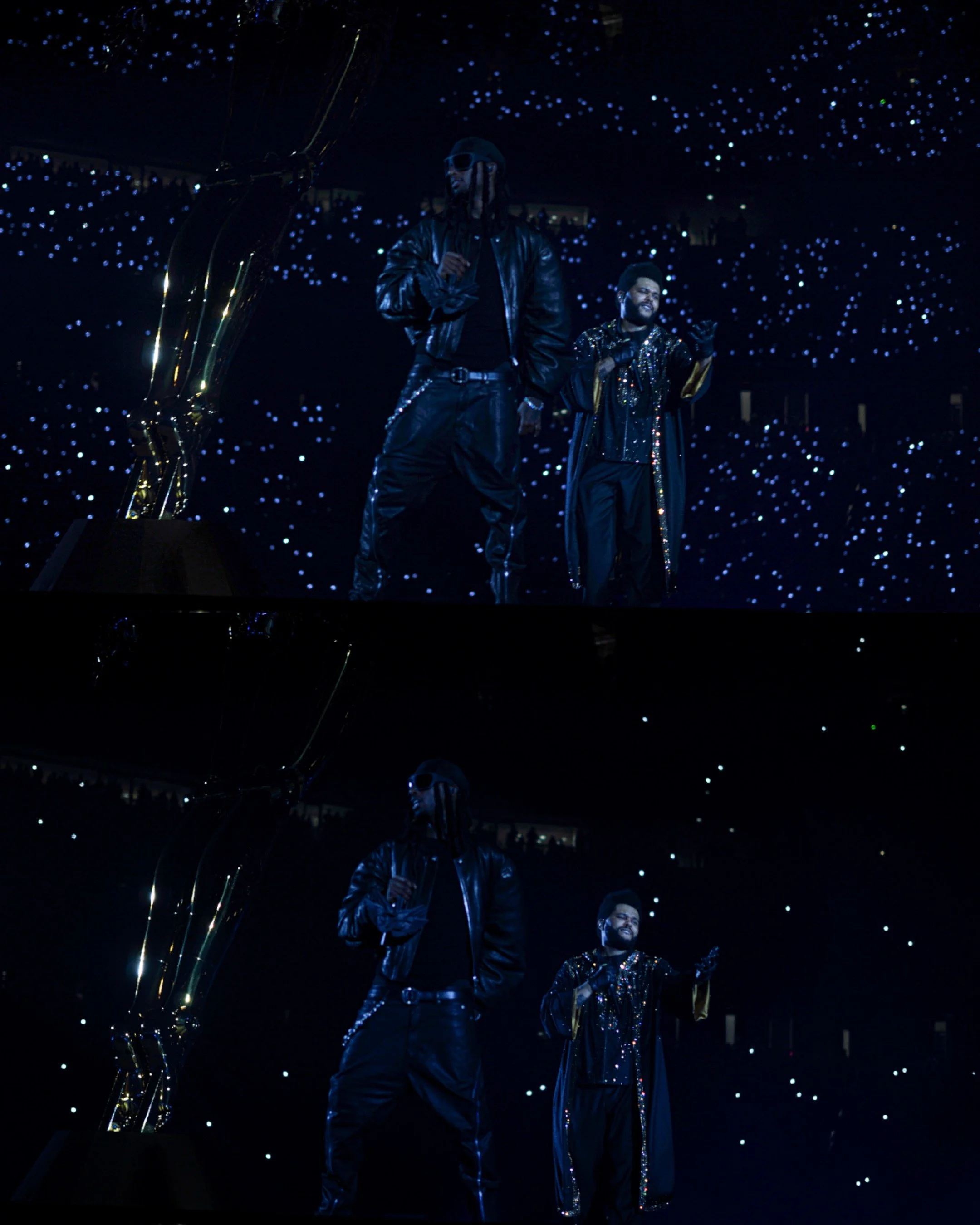 Two men on stage during an award ceremony, with a large golden statue and a starry background.