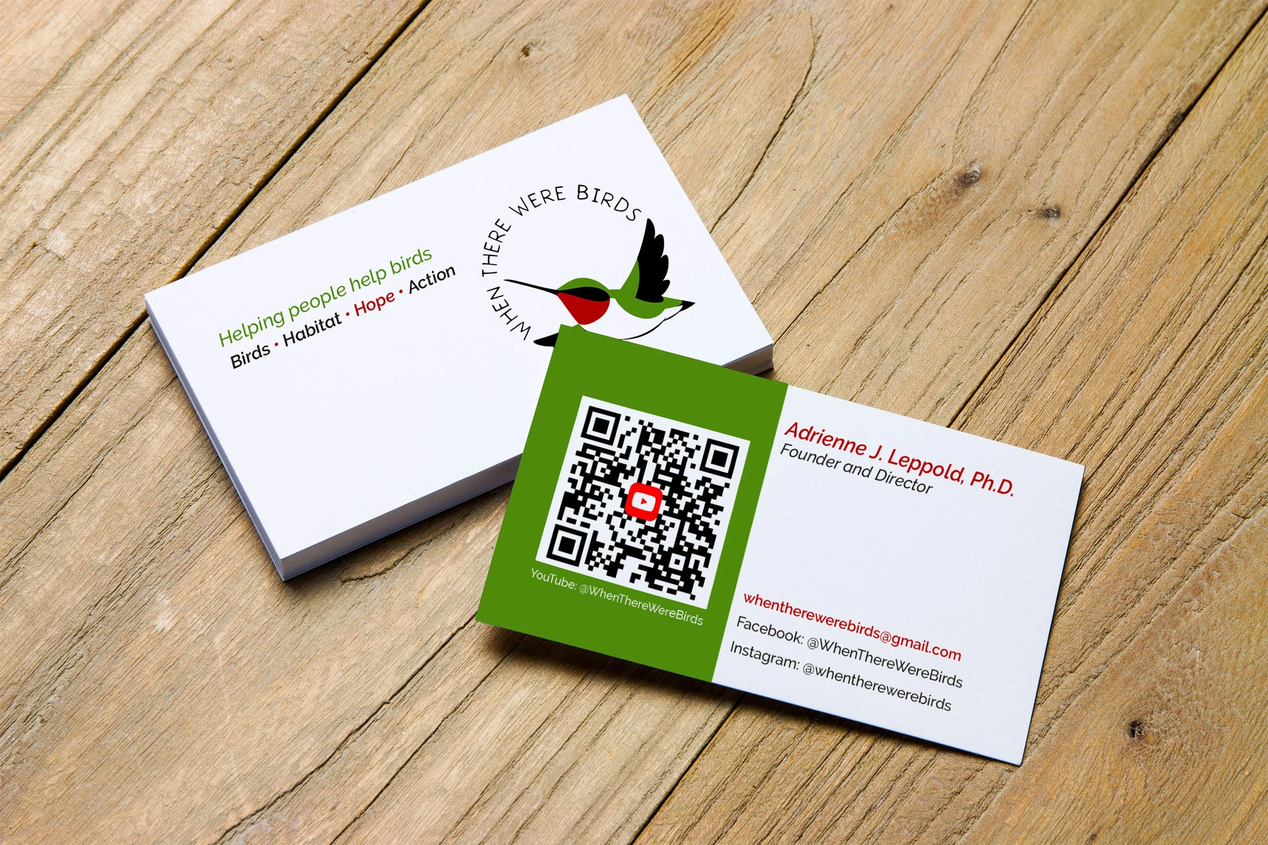 Business card on wooden background showing both front and back views