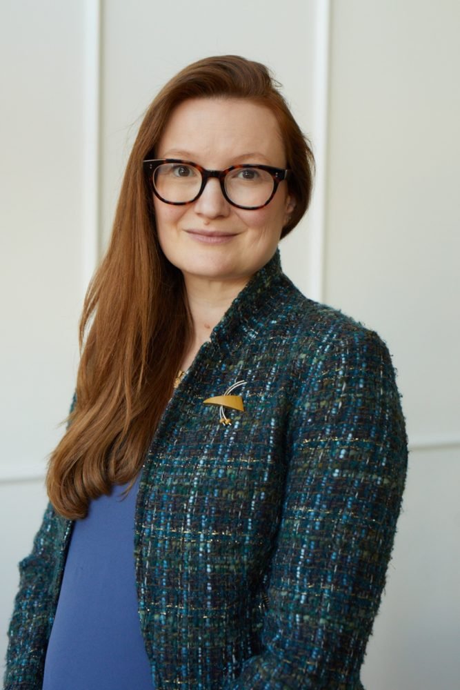 Helen Hodges smiles in a a green boucle jacket..