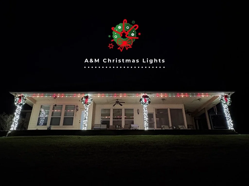 A house decorated with Christmas lights, including wreaths and garlands, at night.