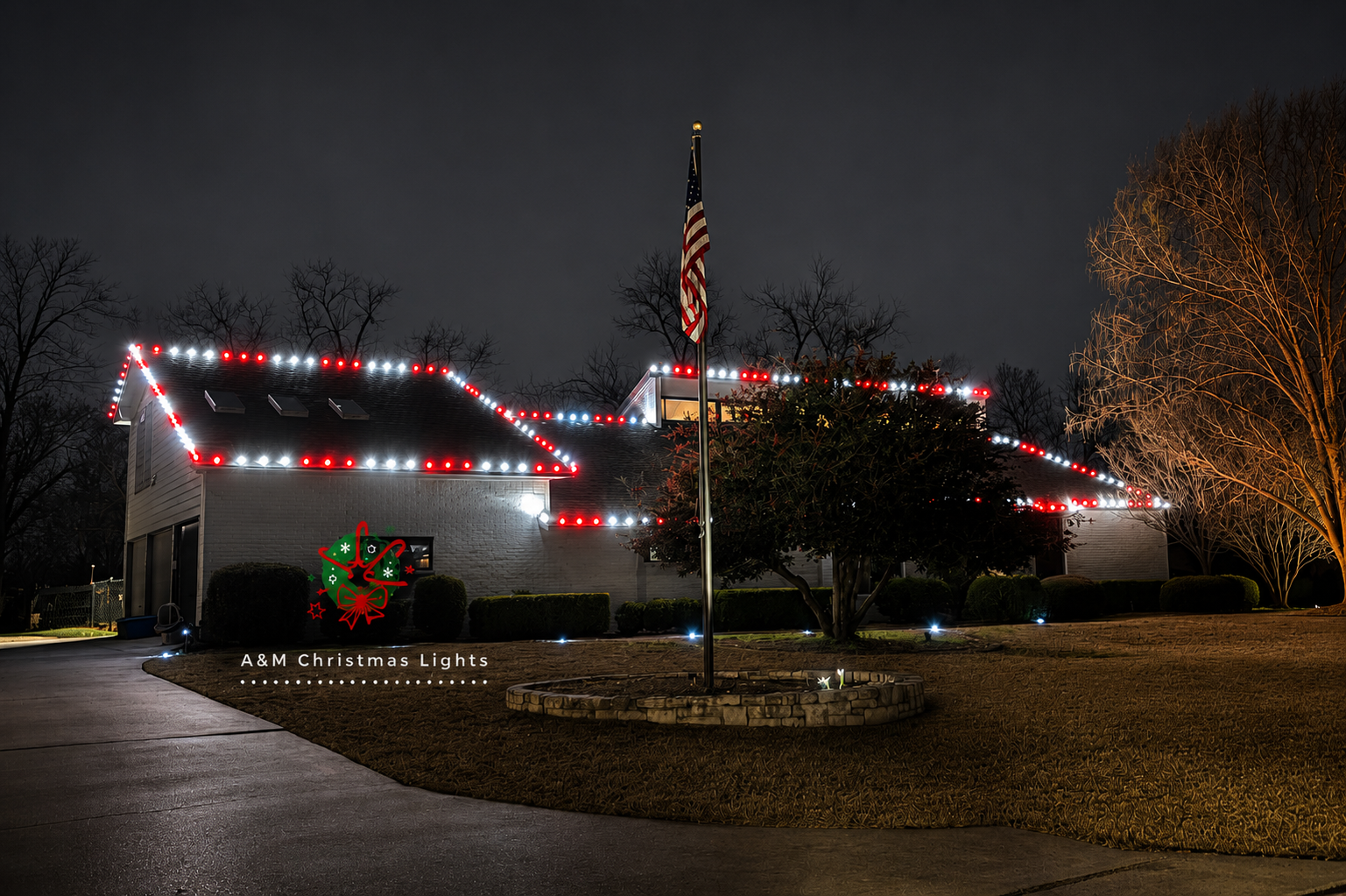 A house decorated with red, white, and green Christmas lights and an American flag in front, with a night sky background and illuminated trees.