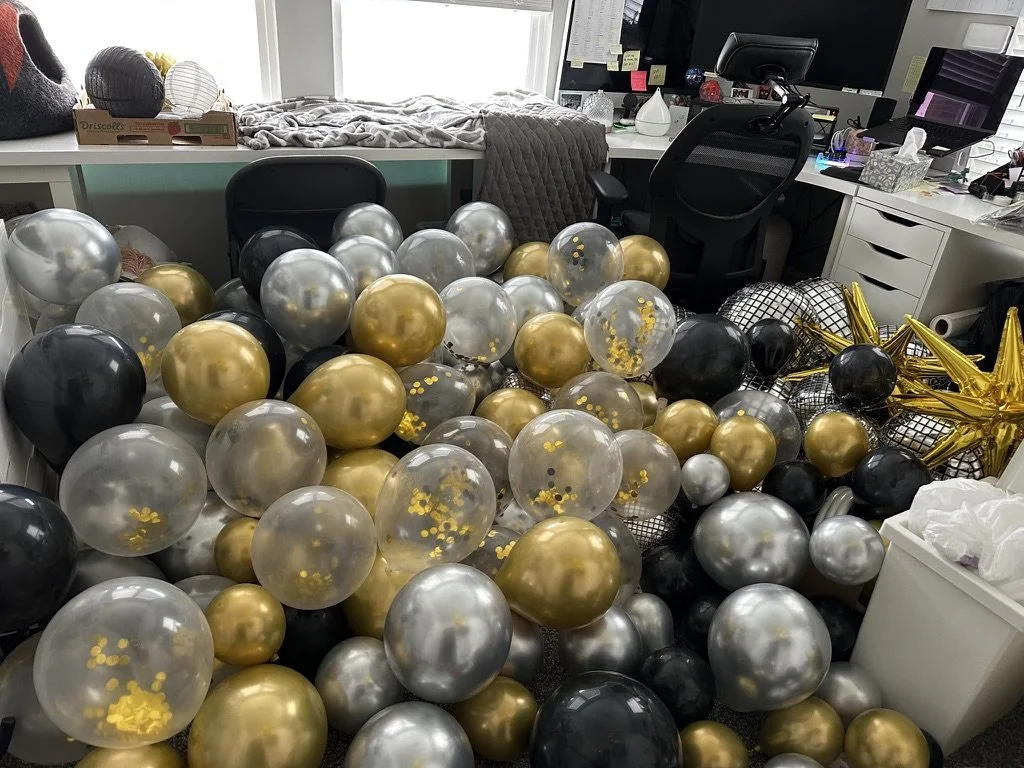 An office floor completely covered with balloons