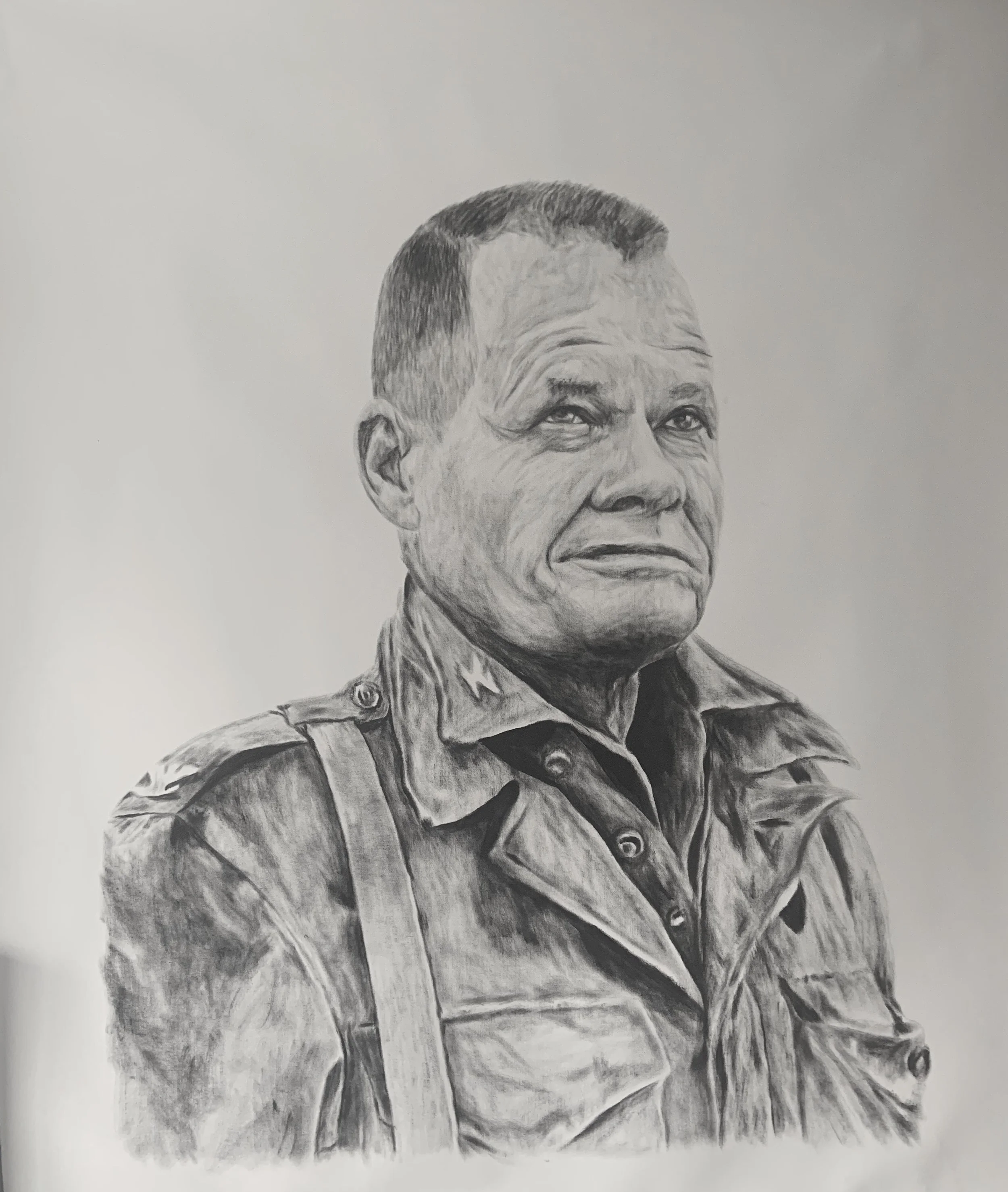 Black and white pencil drawing of a man in military uniform, looking slightly upward with a serious expression.