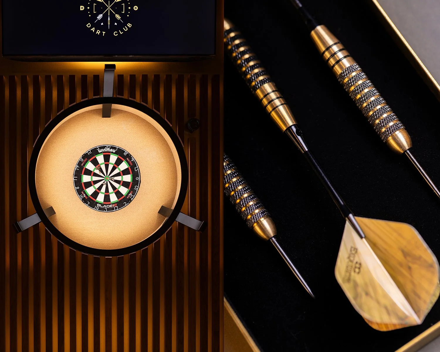 A close-up image of a dartboard in a wooden cabinet with electronic display above, and three metal-tipped darts with gold and black grips resting in a black case.