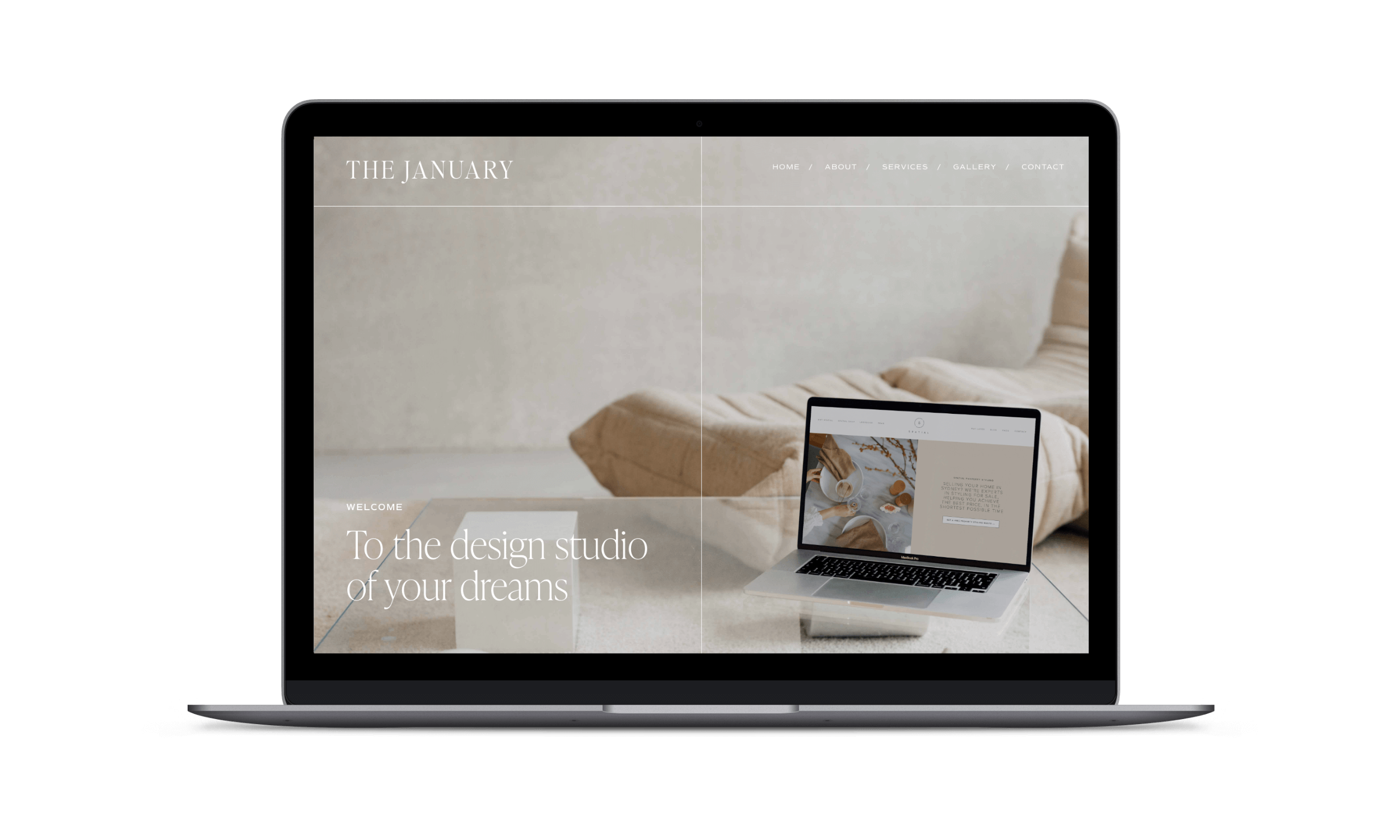 Laptop screen displaying a website with the header 'The January', a navigation menu, and a main image of a bed with a beige blanket and a small laptop on a desk in front of it.