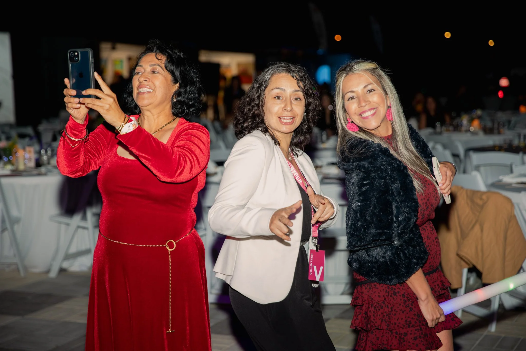 Two professionally dressed individuals, a man and a woman, smiling and posing together at a conference or event, with a screen in the background displaying 'House Democrats'.