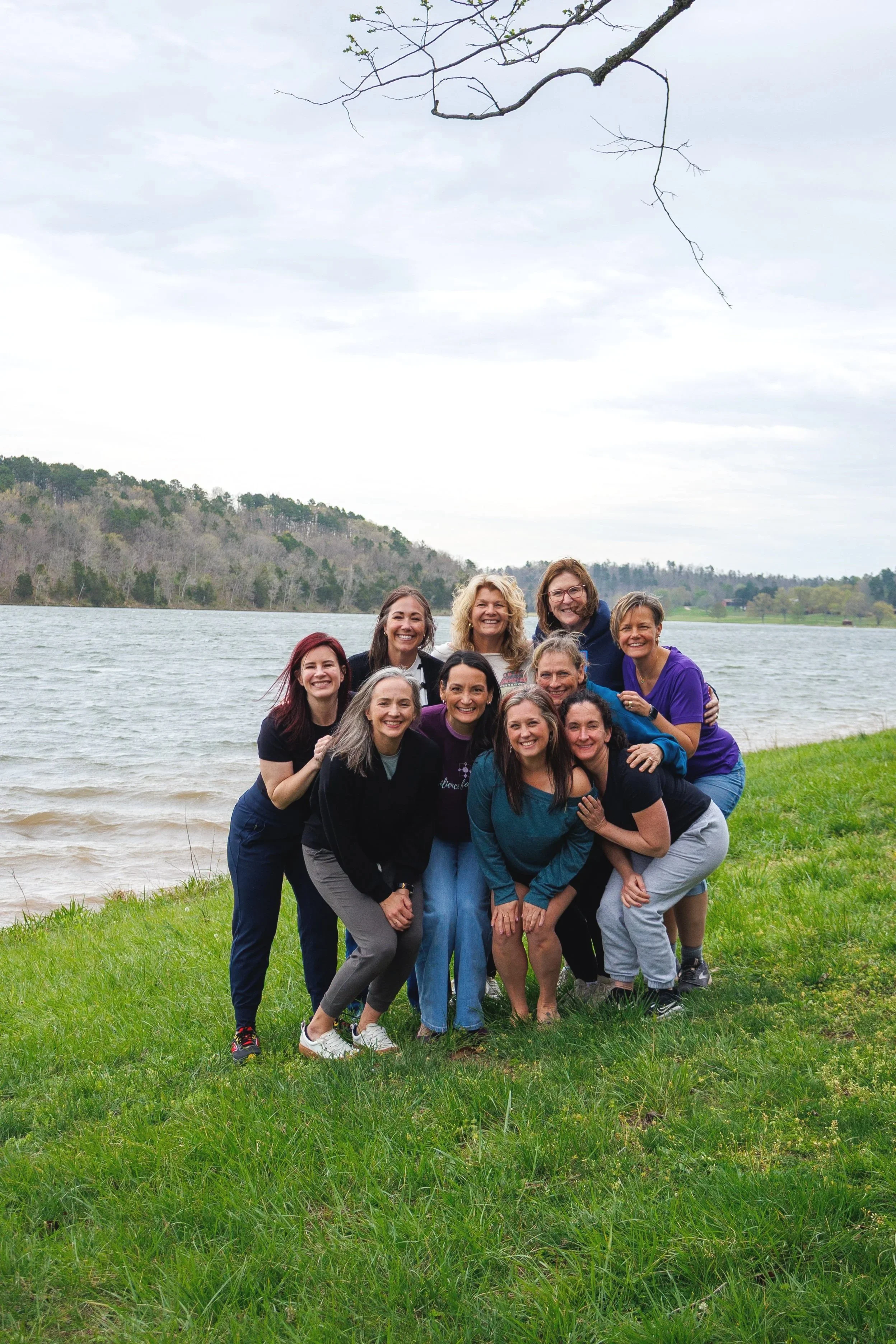 A group of women huddled together at a women's retreat at Trout Lodge near Saint Louis, Missouri