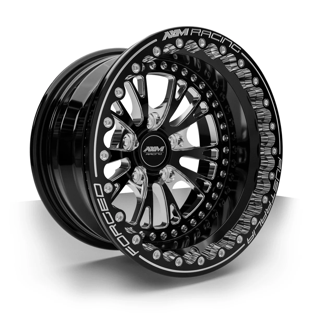 AXM Racing AXR-01 Type B forged rear drag wheel in black with machined accents — three-quarter view