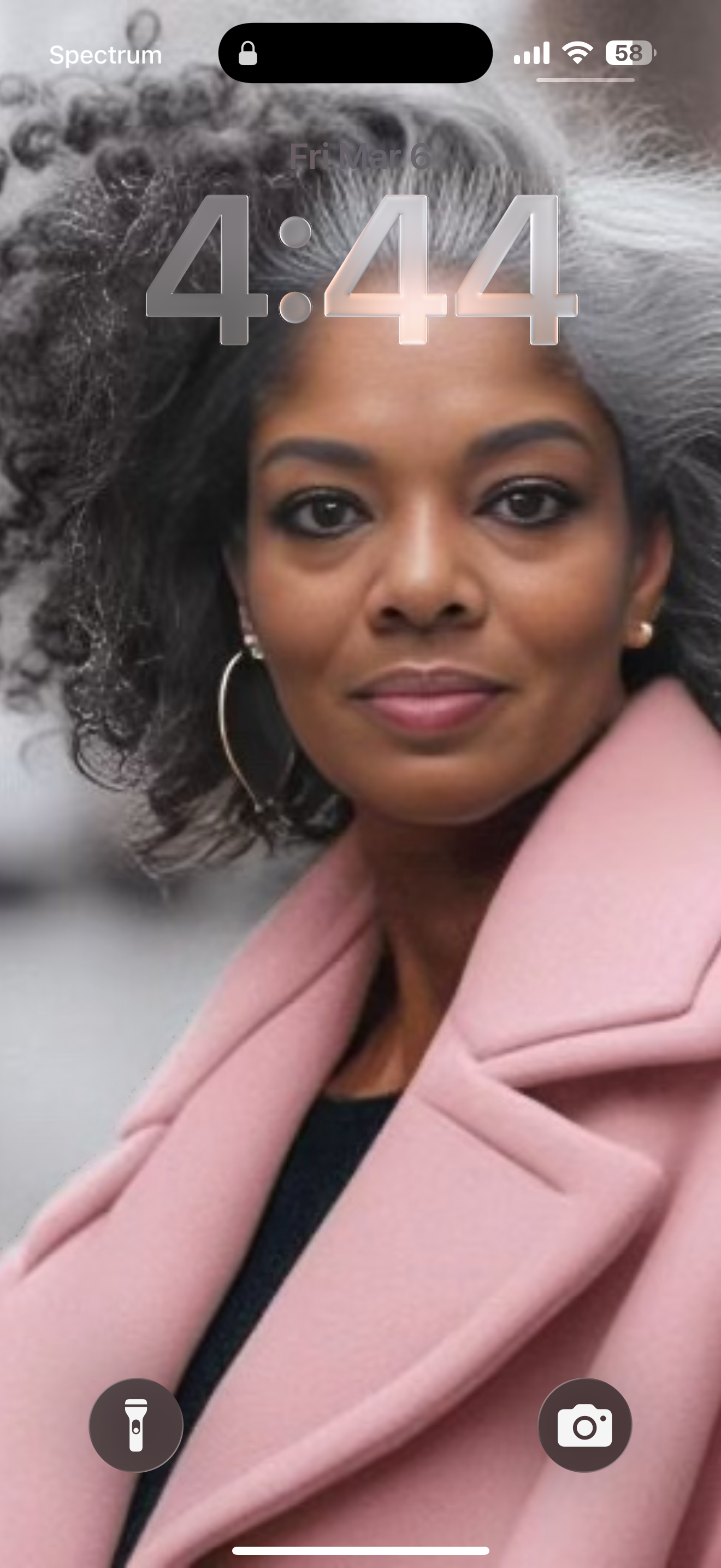 woman in a headshot business pose with beautiful hair in a pink suede coat