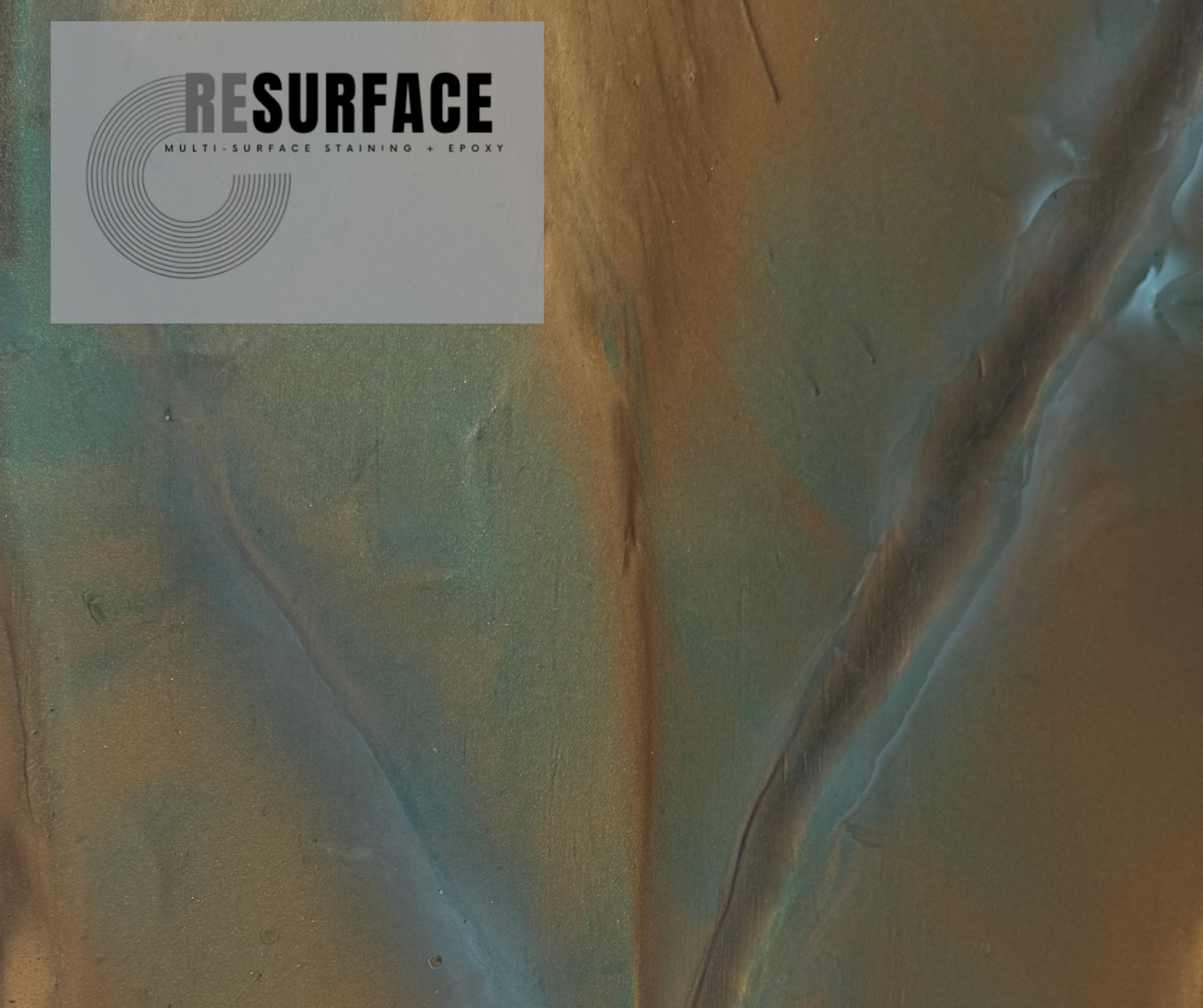 Close-up of a textured, multicolored surface with shades of green, brown, and blue, featuring a logo in the upper left corner with the text 'RESURFACE, Multi-Surface Staining + Epoxy'