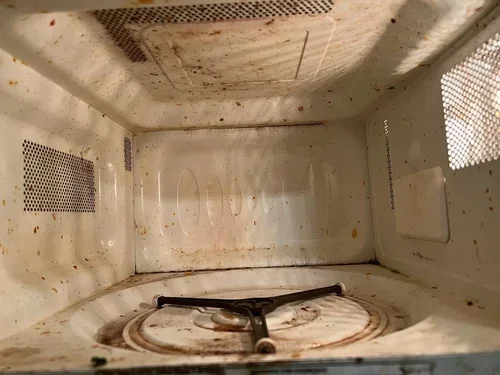 BEFORE - messy microwave as part of light commercial cleaning service *peek the after transformation on next slide