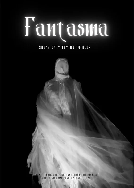 Black and white promotional poster for a movie titled 'Fantasma.' The poster features a ghostly figure draped in a flowing, semi-transparent fabric. The title is in large, stylized font at the top, with the tagline 'She's only trying to help' underneath.