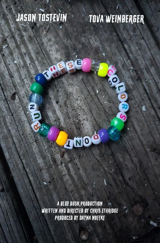 Colorful letter beads spell out "THESE THOSE COLOR SOUND" arranged in a circle on a wooden surface, with text credits for a production written below.