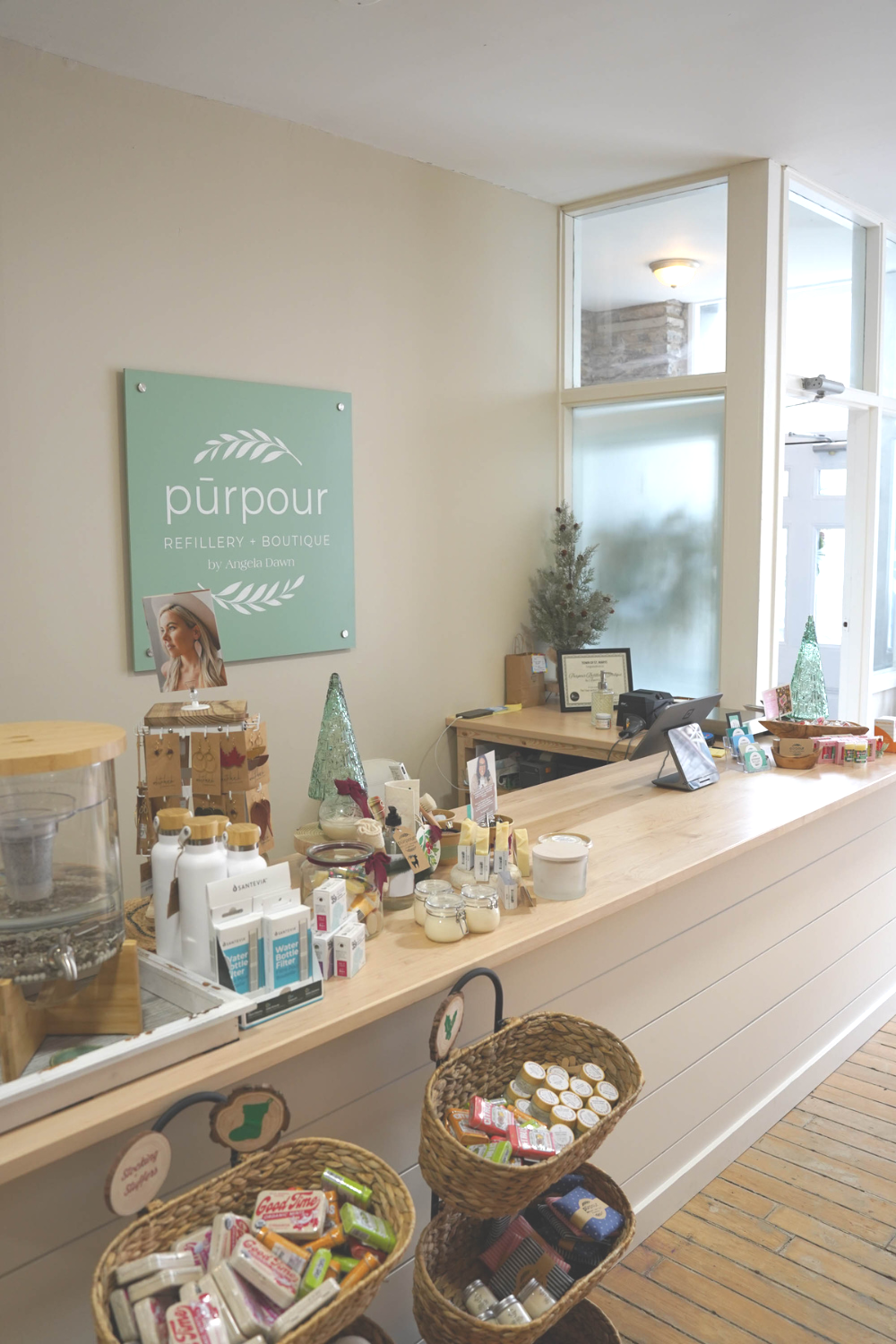 the cash desk with products on the counter and the store sign on the wall