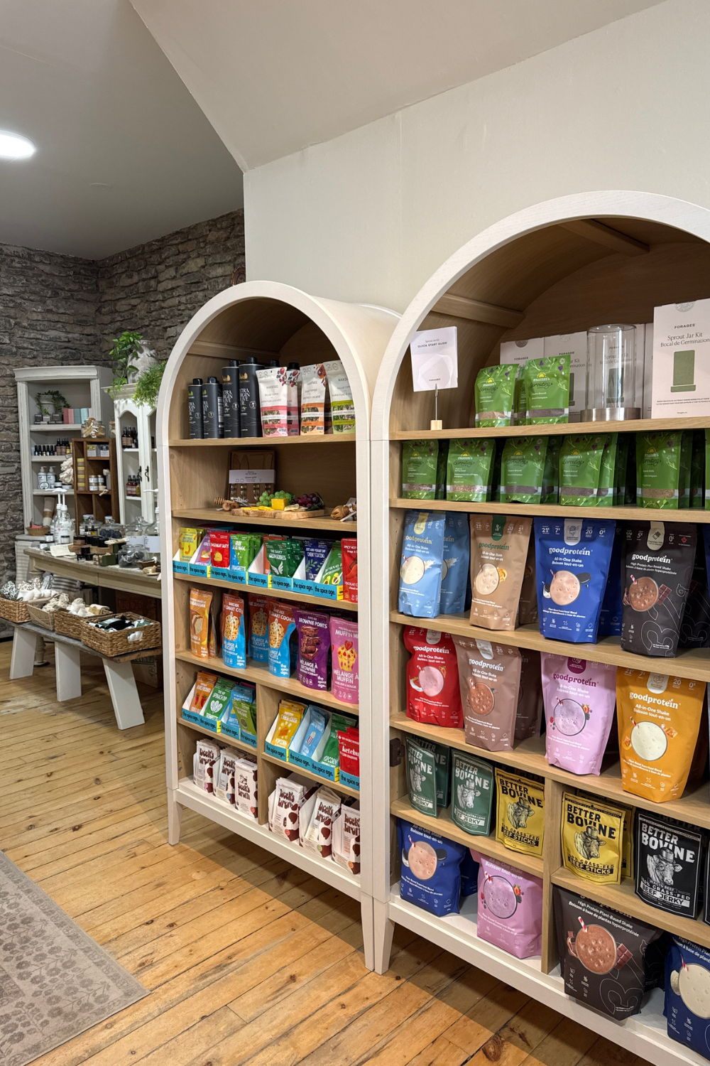 Shelves filled with packaged food items. Protein Powder, beef jerky, Bone broth