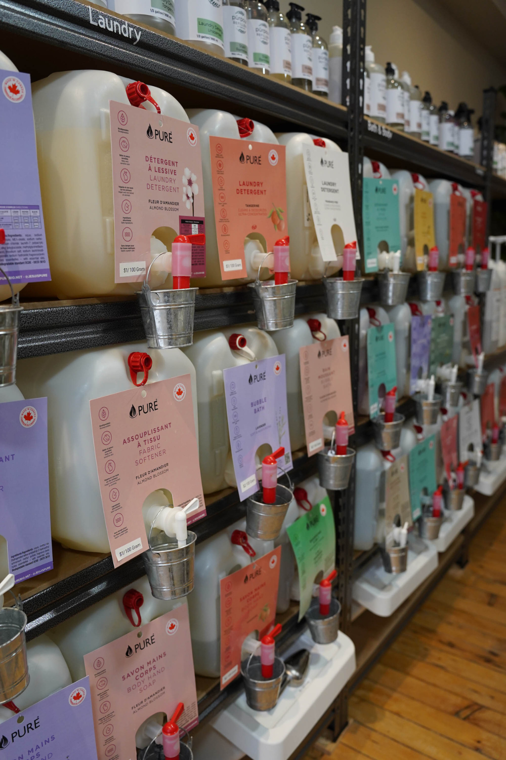A side view of large jugs of home cleaners for refilling