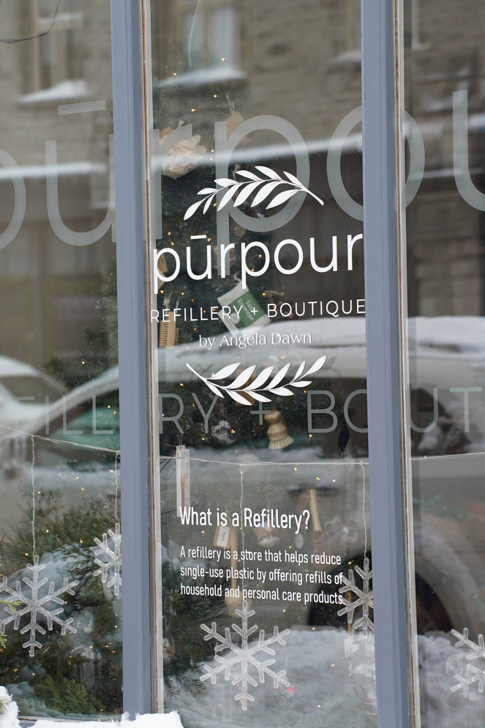 The front window of the store with the window sign