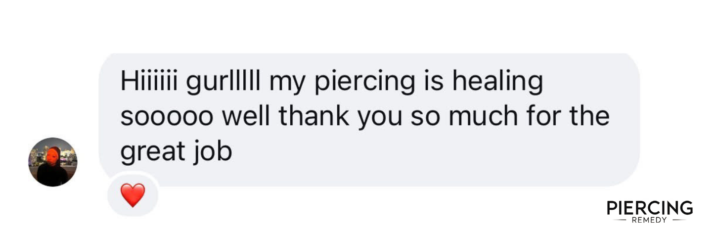 Screenshot of a text message confirming healing of a piercing with a heart emoji and the branding of Piercing Remedy.