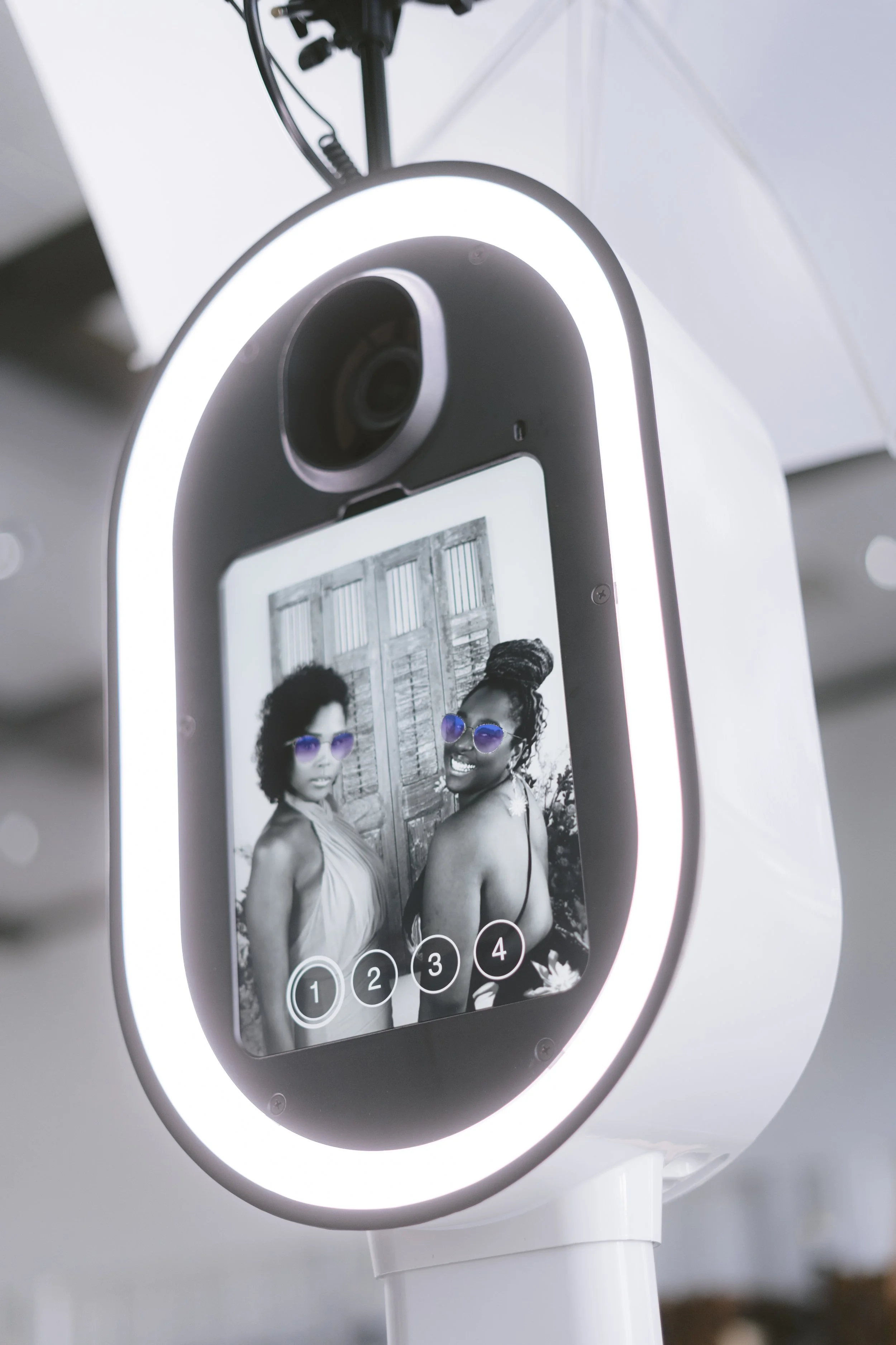 2 ladies on photo booth screen with purple aviator glasses filter