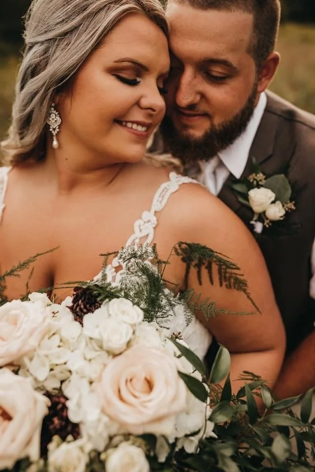 Laurie’s customers, Fernando and Kate embracing by the lake on their wedding day.