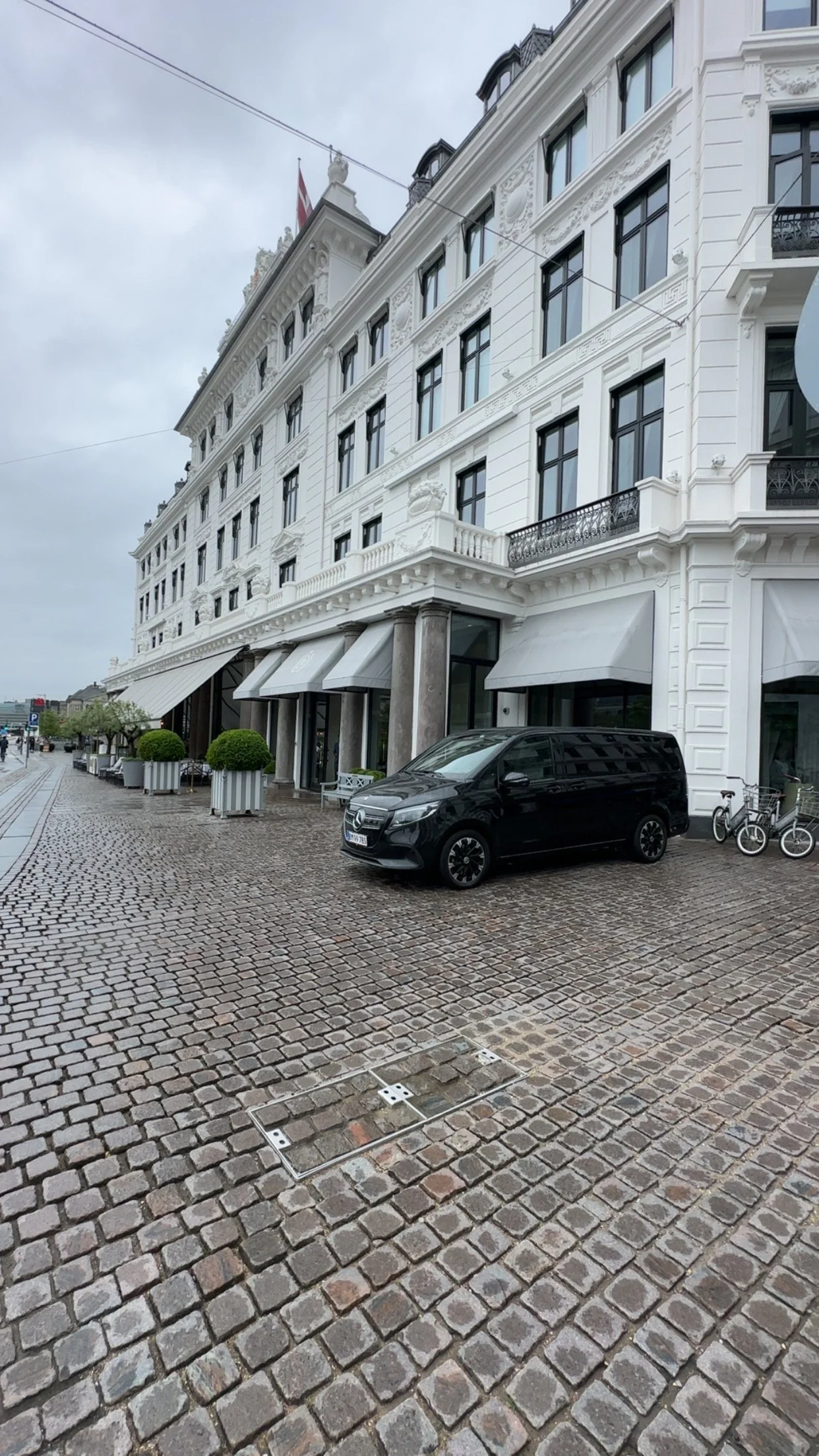 Luxury Mercedes van parked outside Hotel D’Angleterre in Copenhagen, ready for private VIP transfers with 24K Transfers