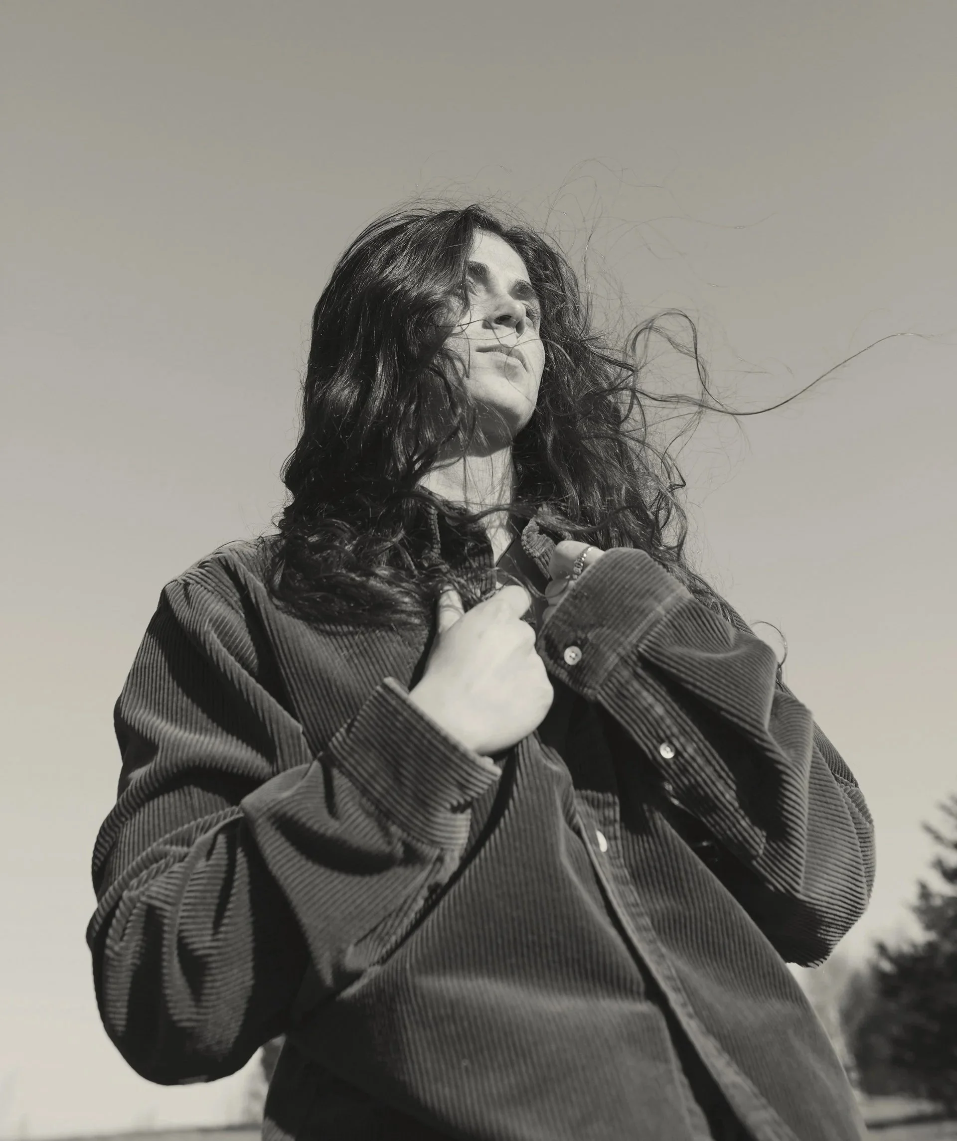 Black and white photo of a happy woman customer with positive review.