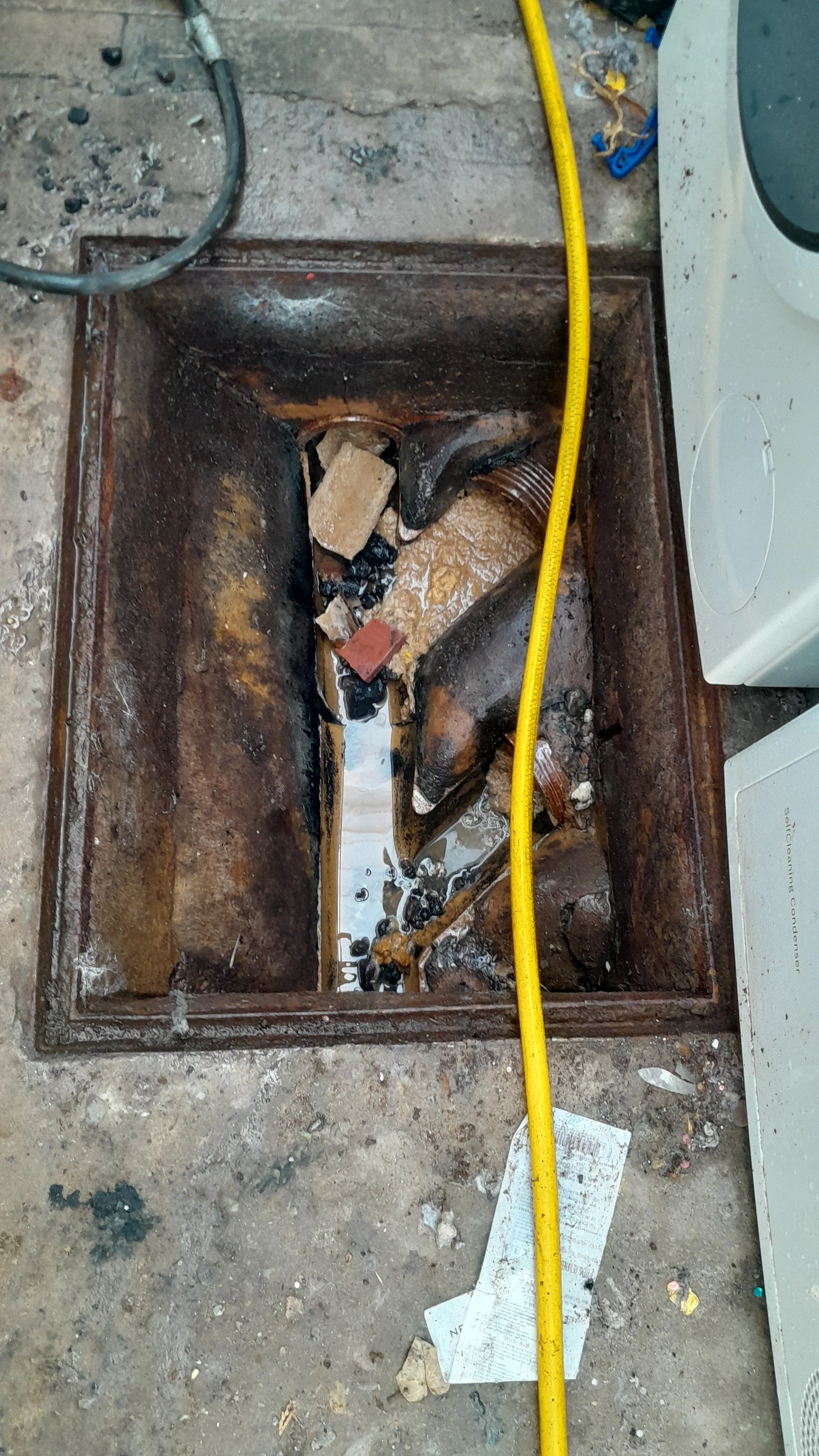A broken drainage system needs to be cleared prior to replacement.