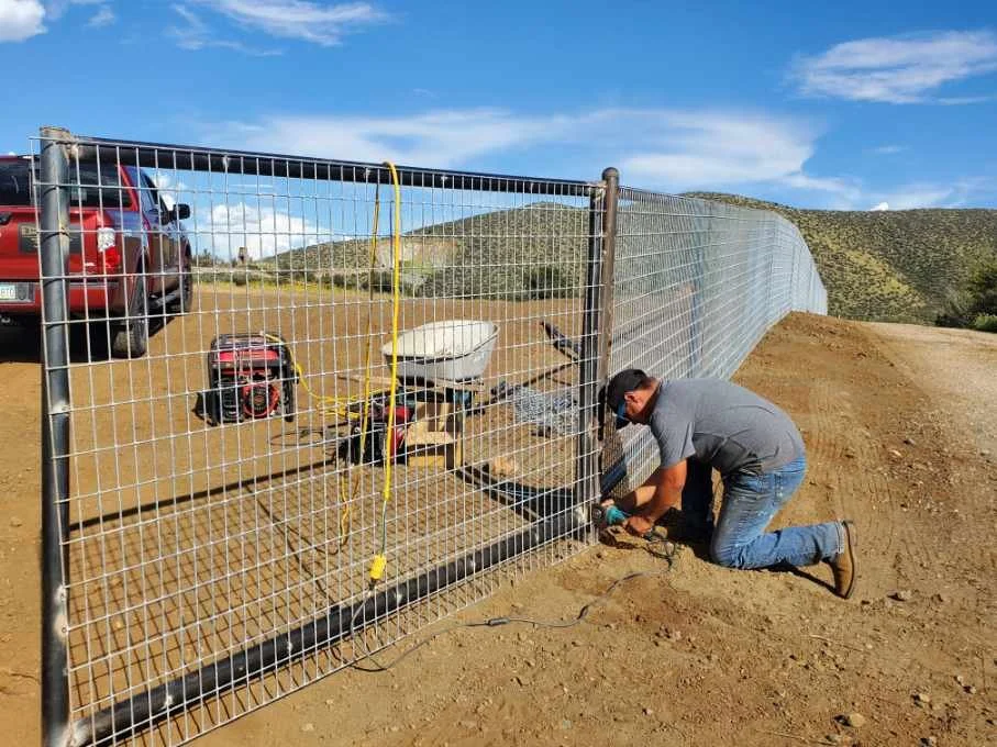 Fence installation work showing trade coordination on a residential project.