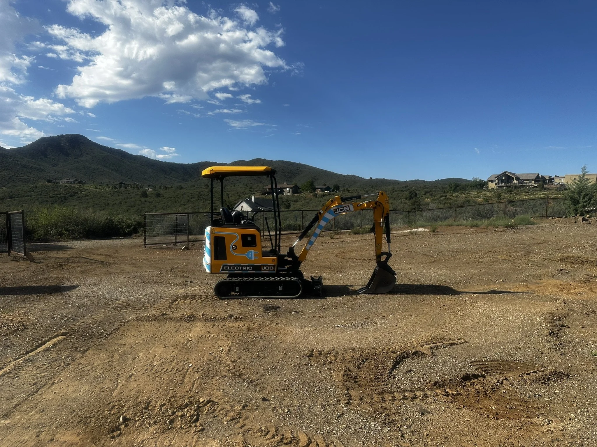 Mini excavator on a graded residential site in Prescott, Arizona.