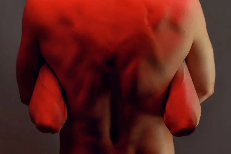 Late Night Show: close-up of a red-lit bare torso