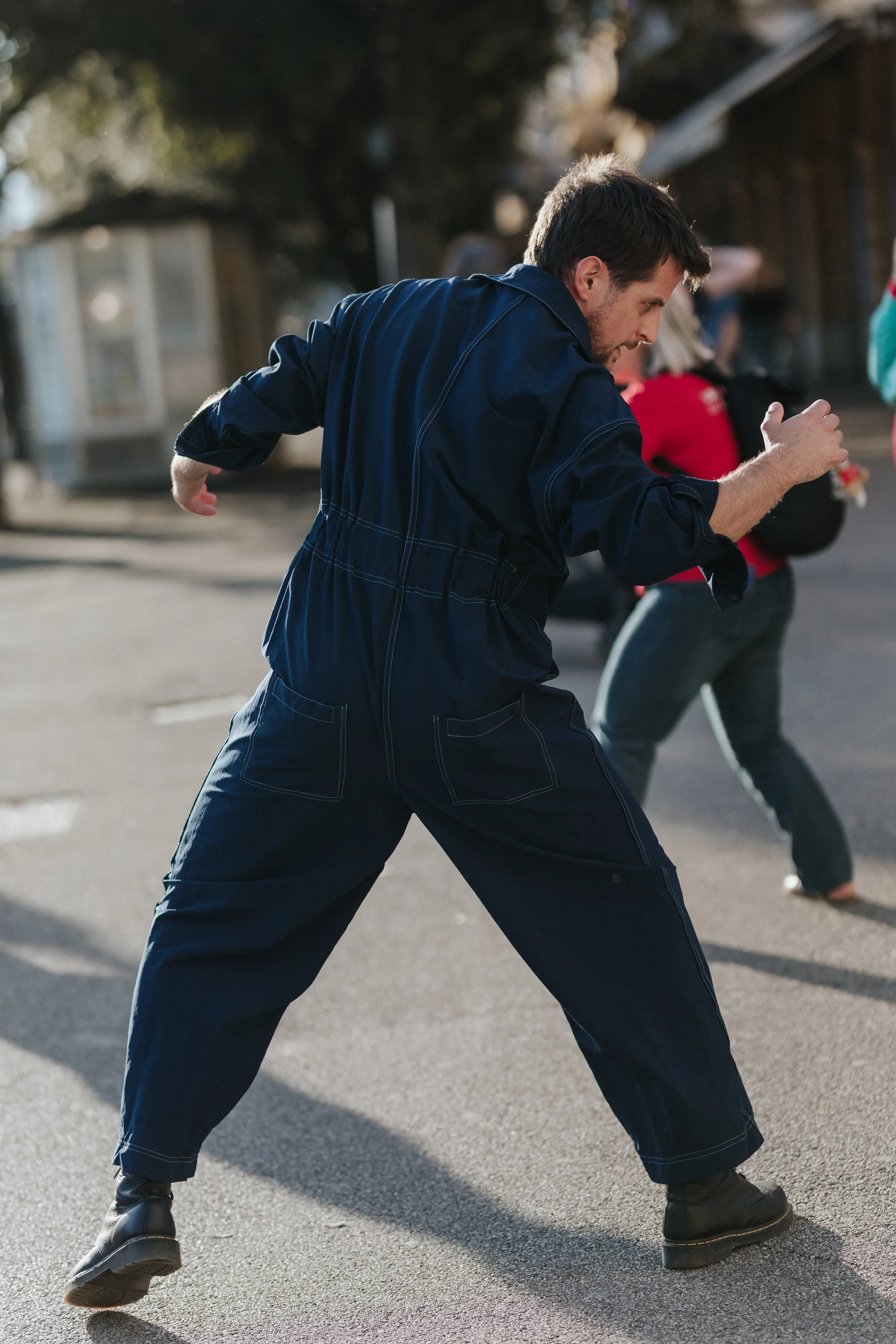 Gyula Cserepes dancing in a street in navy workwear, Seagulls Fly Early