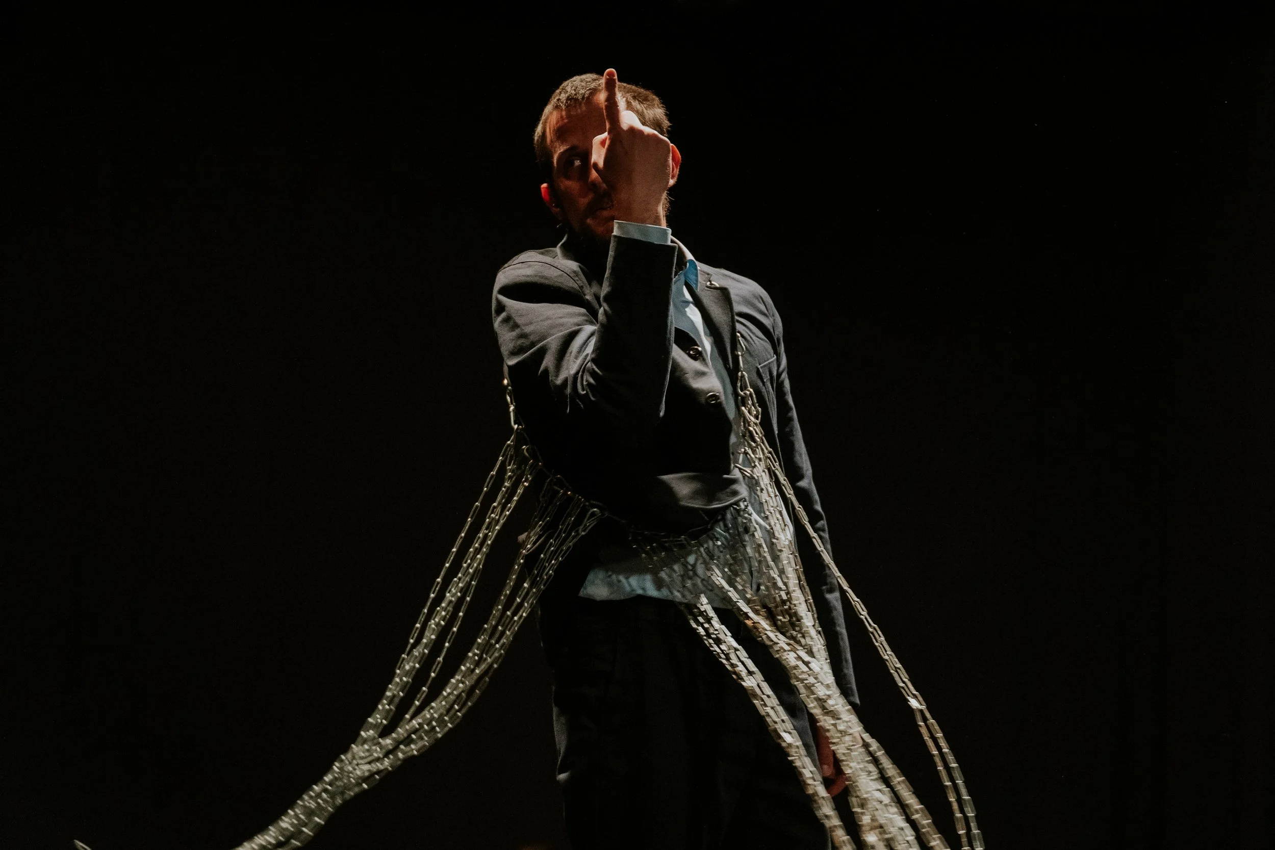 Fragile: Gyula Cserepes in a long fringed garment against a black background