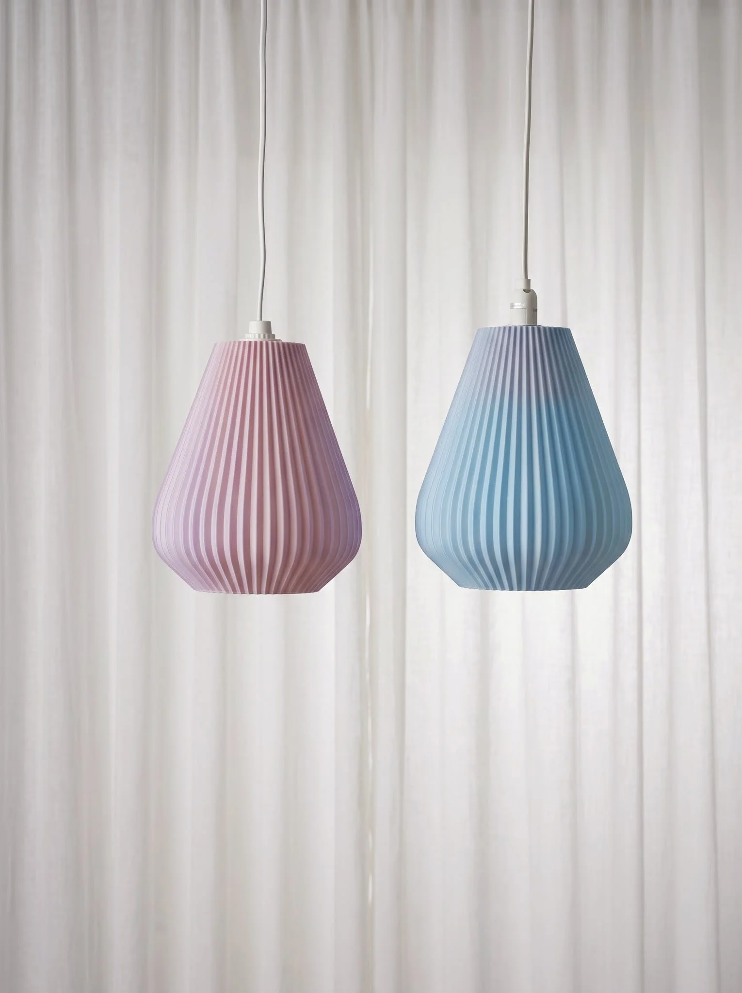 Yellow decorative table lamp with a ribbed glass shade on a wooden base, placed on a white surface.