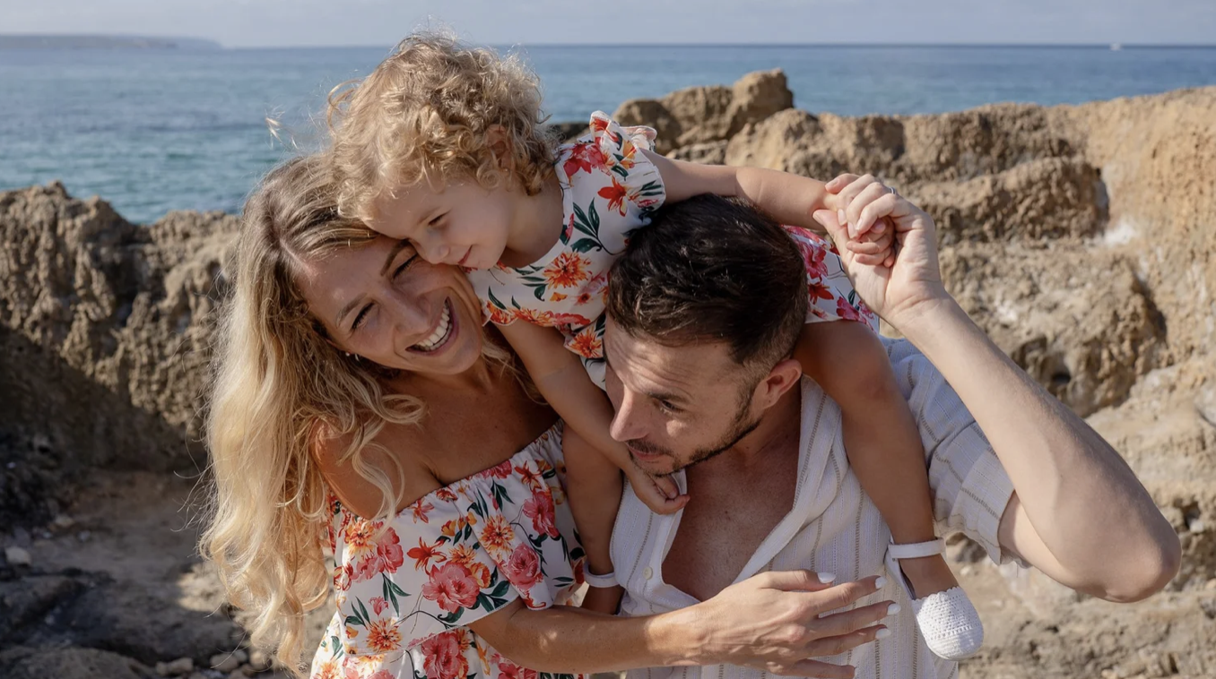 Family laughing and playing during outdoor photoshoot in Mallorca