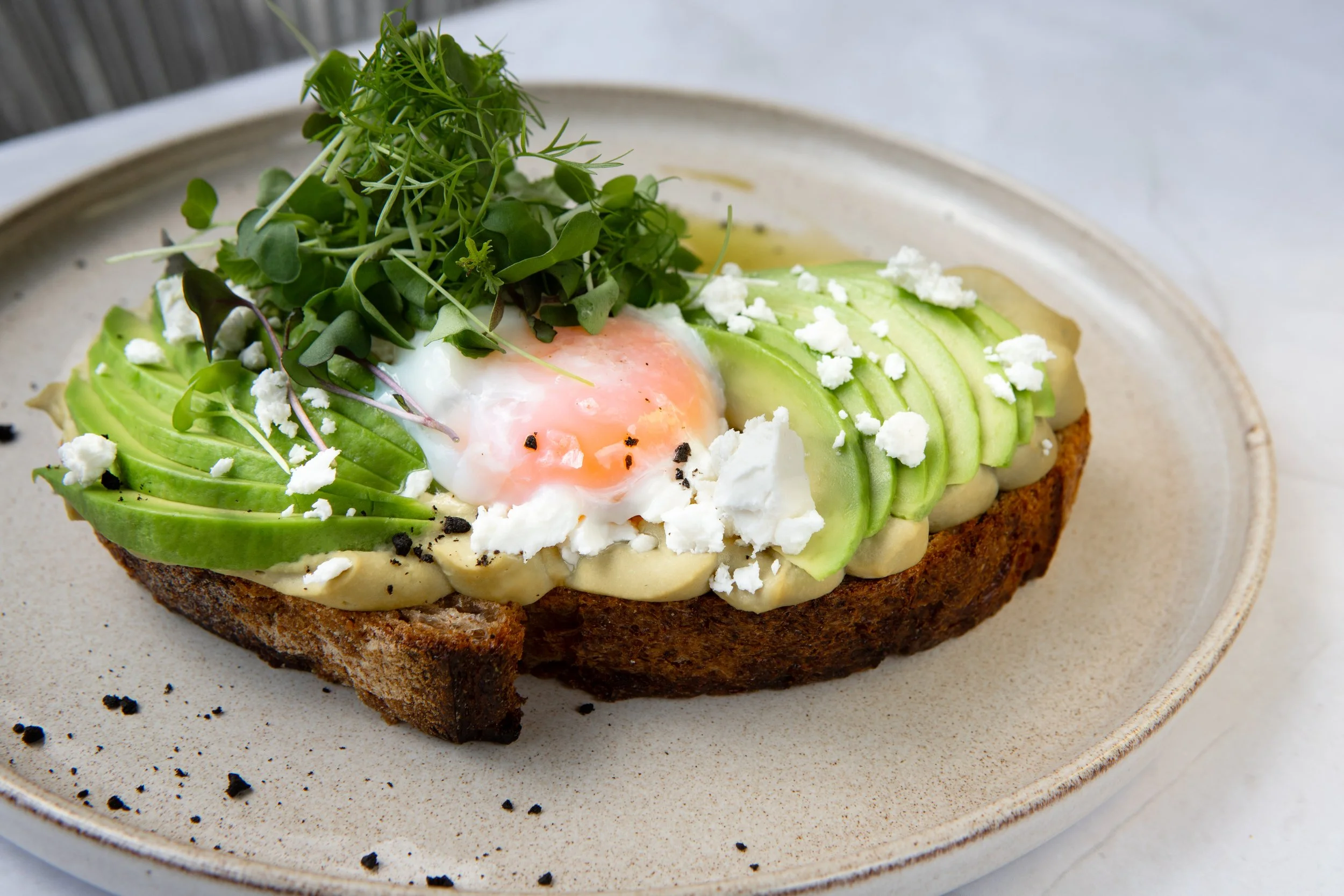 Avocado toast with soft-boiled egg, microgreens.