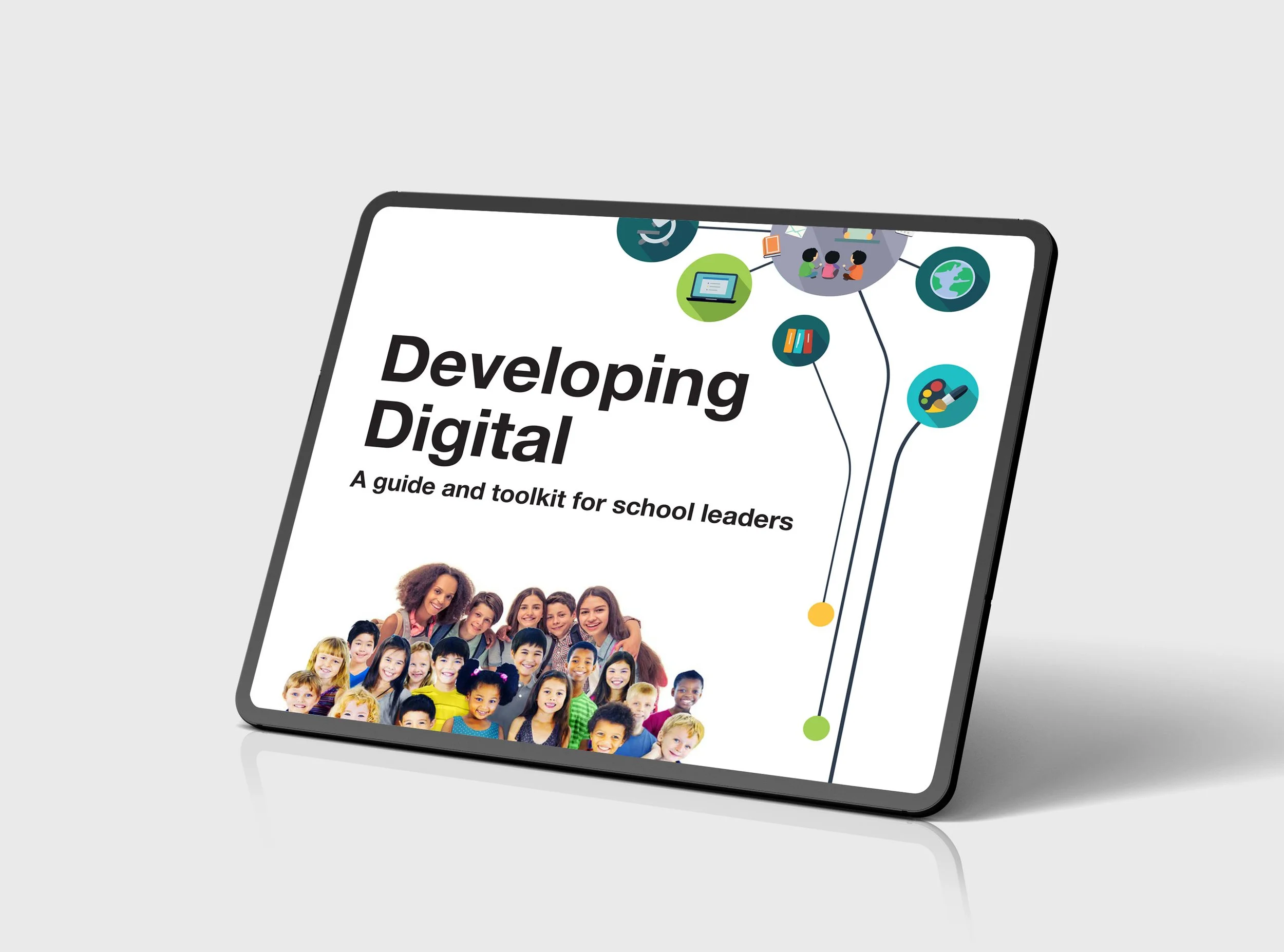 A tablet displaying a cover page for a guide titled 'Developing Digital,' featuring a group photo of smiling children from diverse backgrounds.