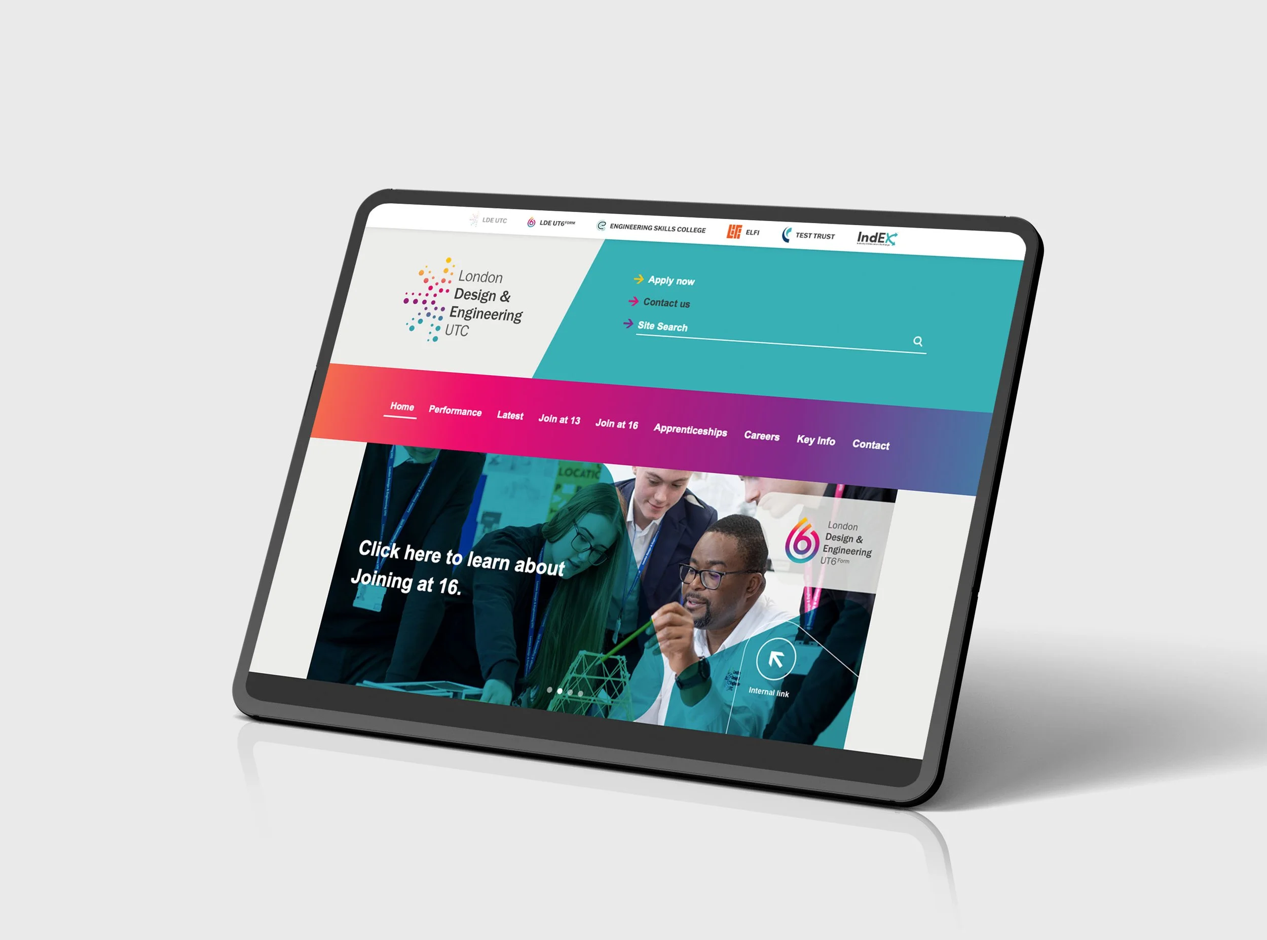 A tablet screen showing the website for London Design & Engineering UTC, with a colorful header, navigation menu, and a group of young people working together.