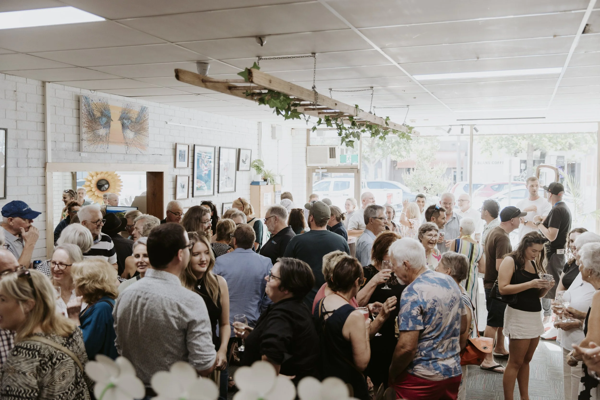 Social gathering at Tank Art Gallery with people enjoying enjoying art and conversation