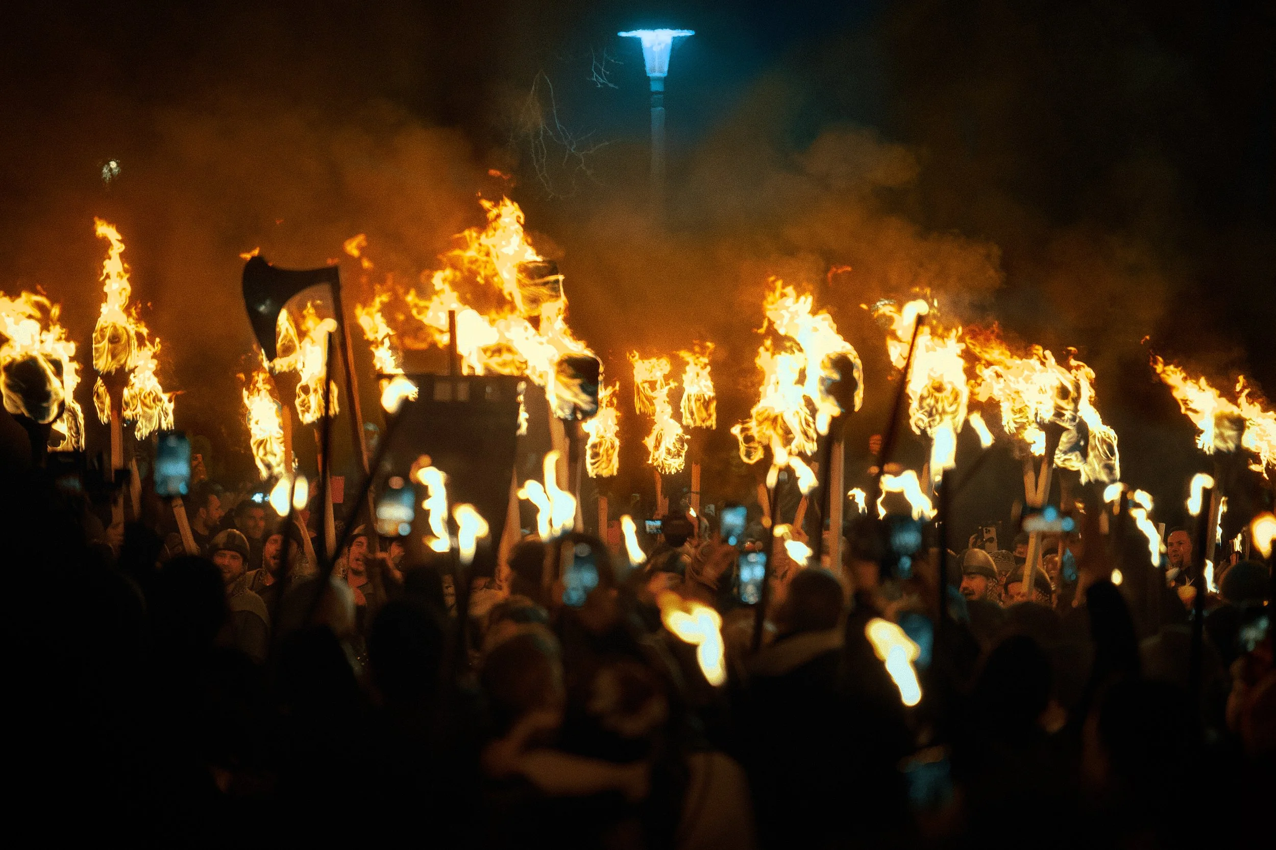 Marchers hold torches as they walk along the procession route for Edinburgh's 2025 Hogmanay celebration.