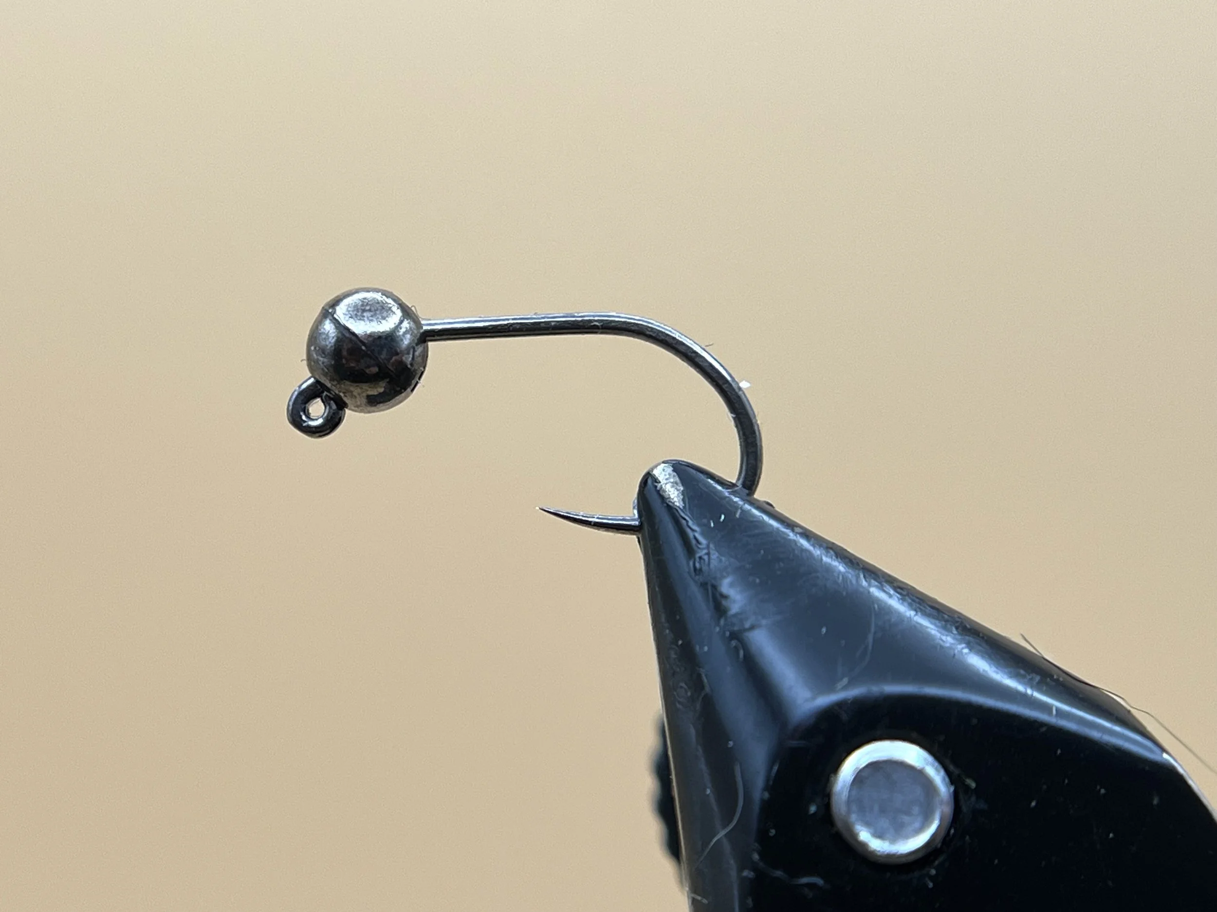 Thread a slotted bead on the hook and place it in your vise