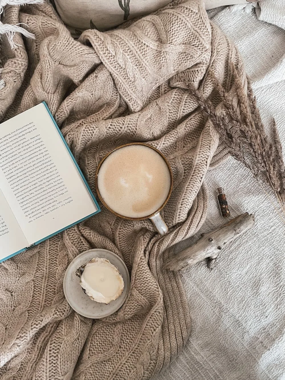 coffee cup on blanket with book