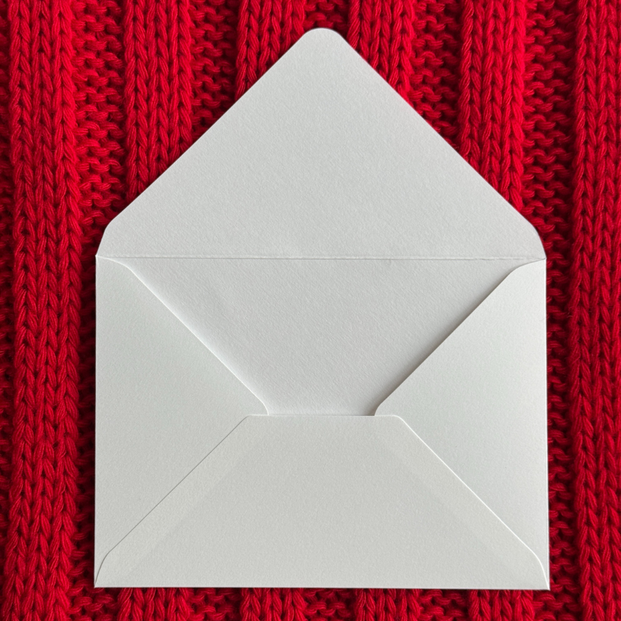 envelope on red knitted background