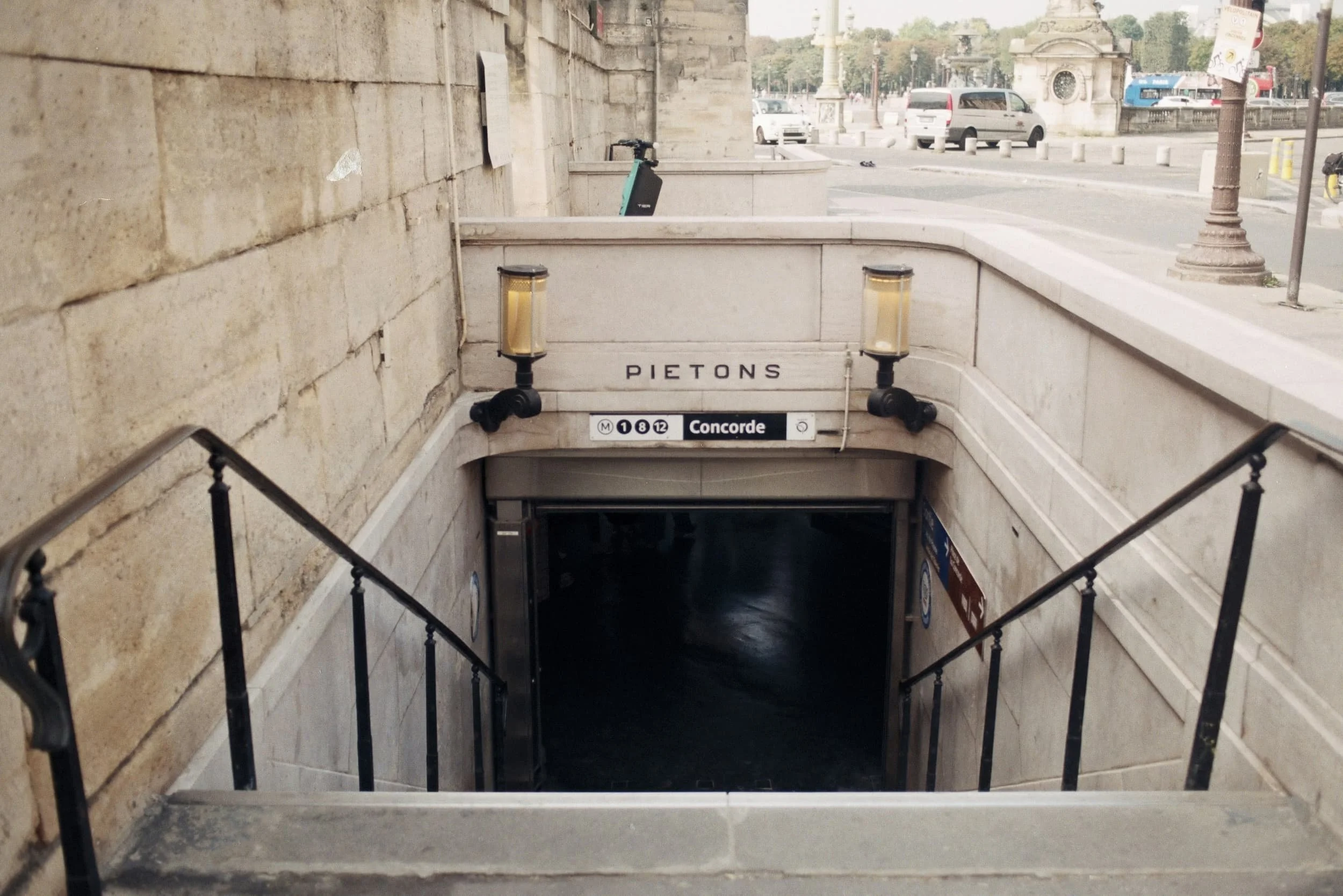 staircase leading to paris metro with signs