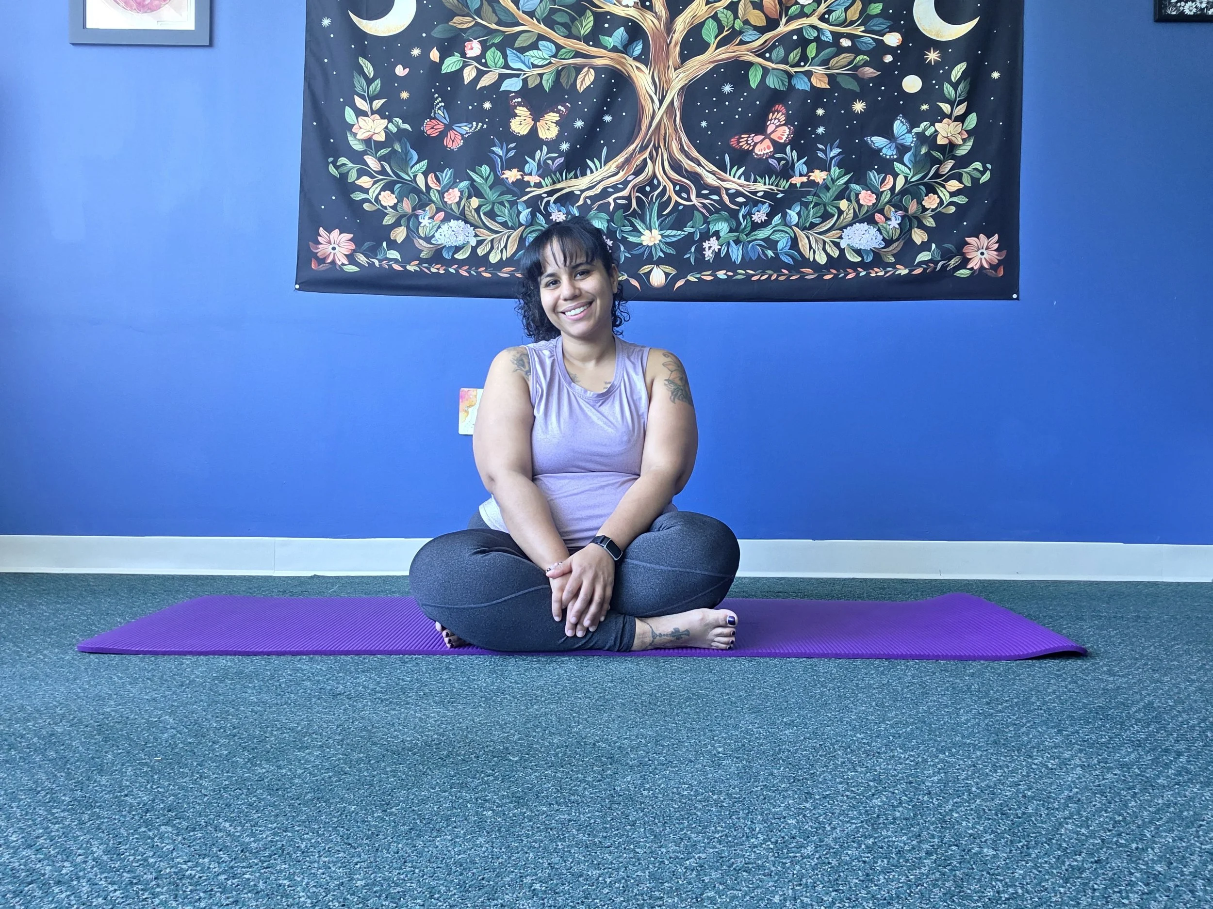 Pilates Instructor Seated Smiling Mat Legs Crossed